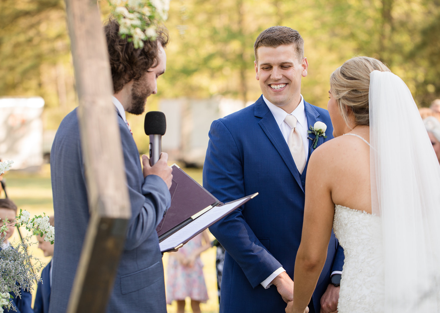 groom and bride smiling as they hear their wedding ceremony speech