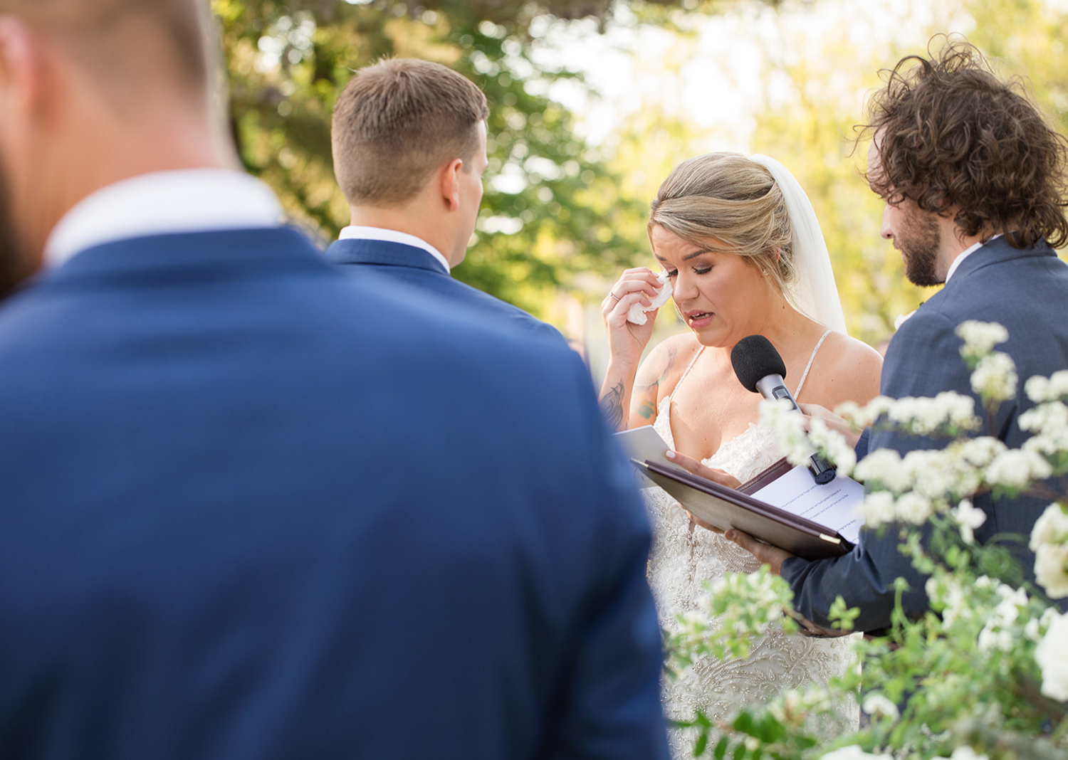 bride tears up as she reads her wedding vows 