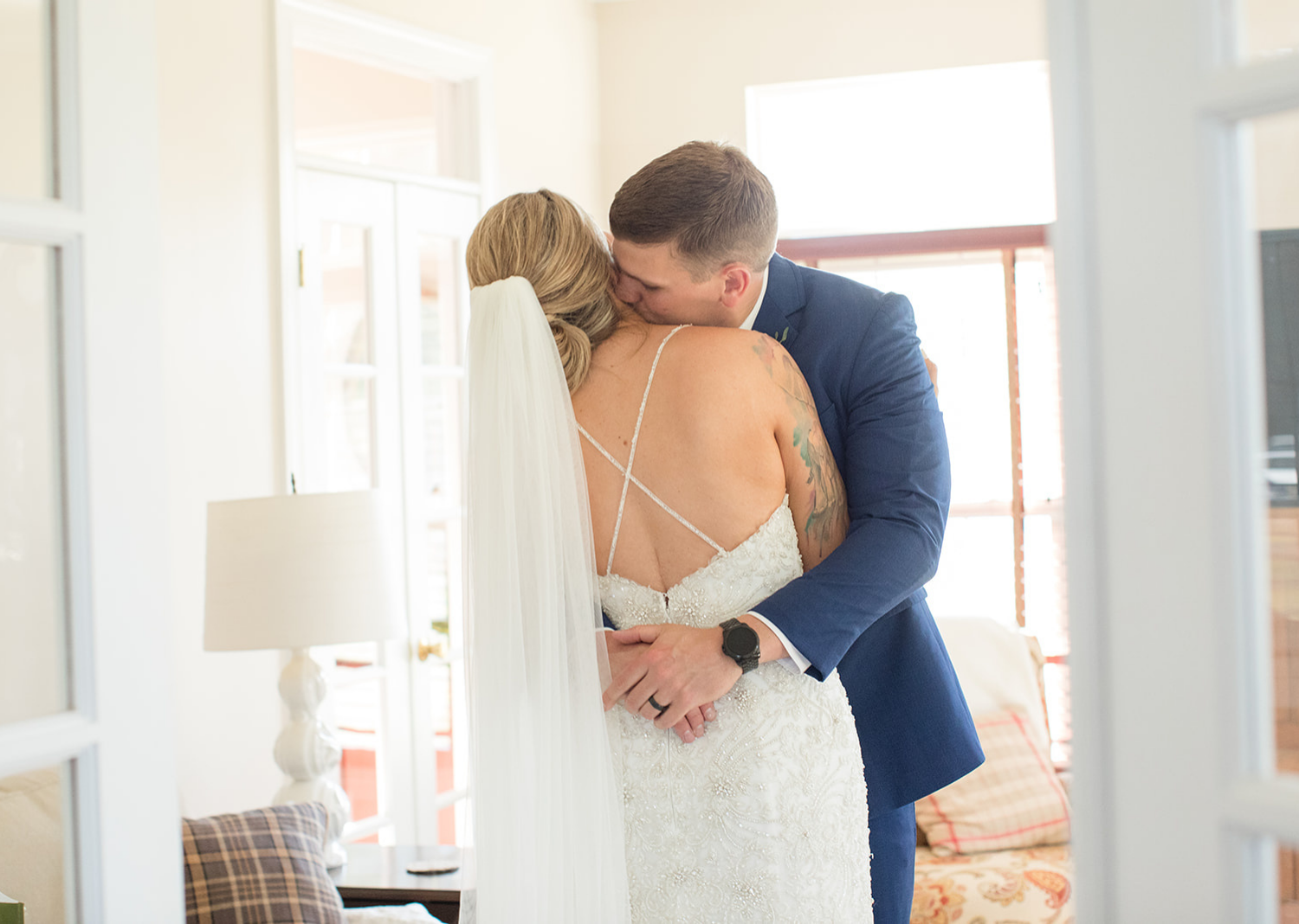 groom hugs his bride as he sees her before the wedding ceremony