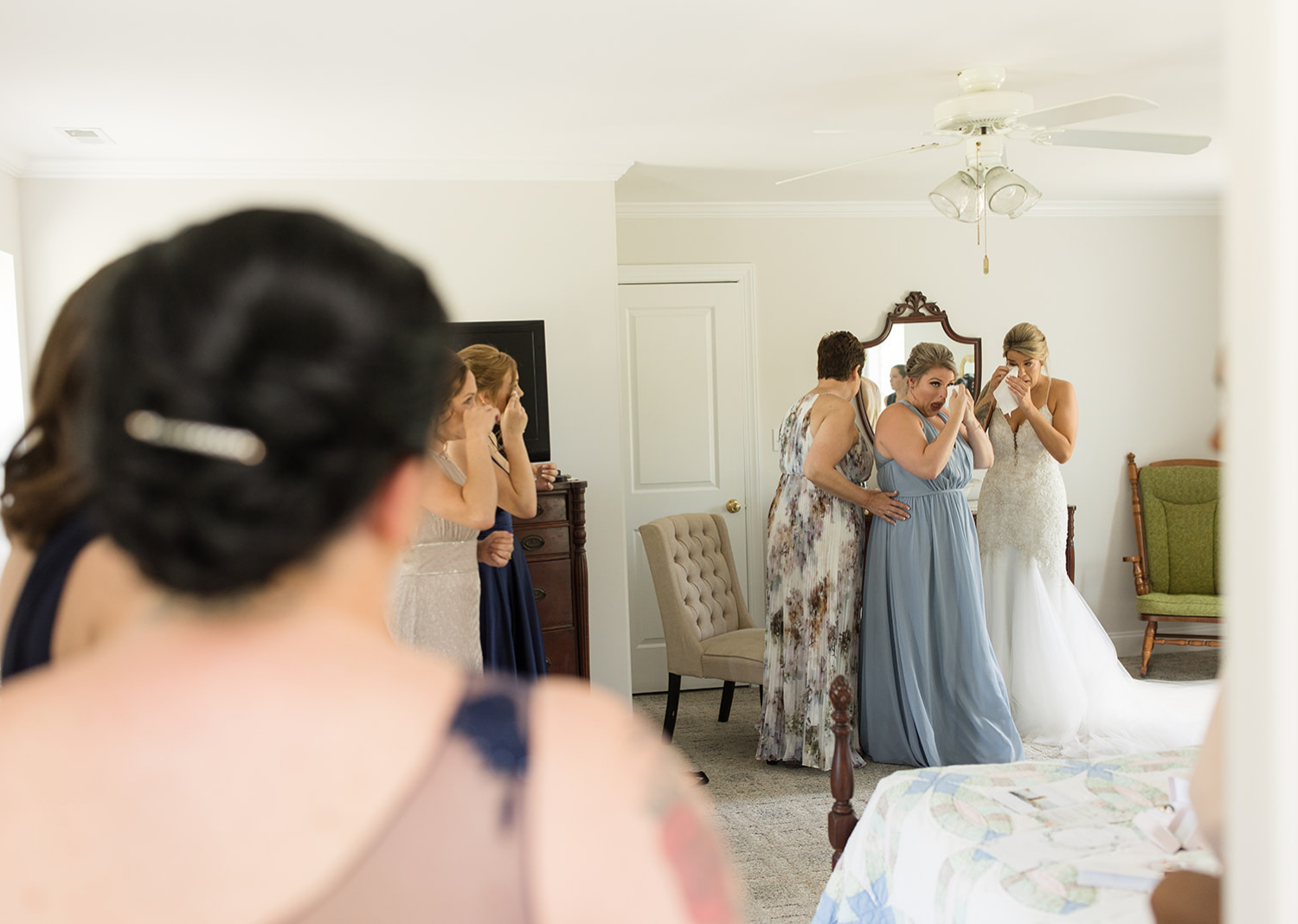 bridal party crying with the bride as they get ready for the wedding