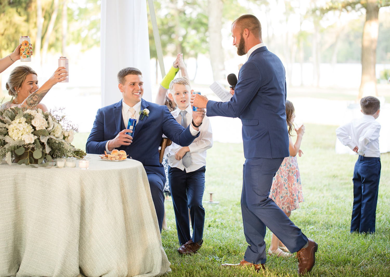 groom and groomsmen toast as groomsmen is giving his wedding speech 