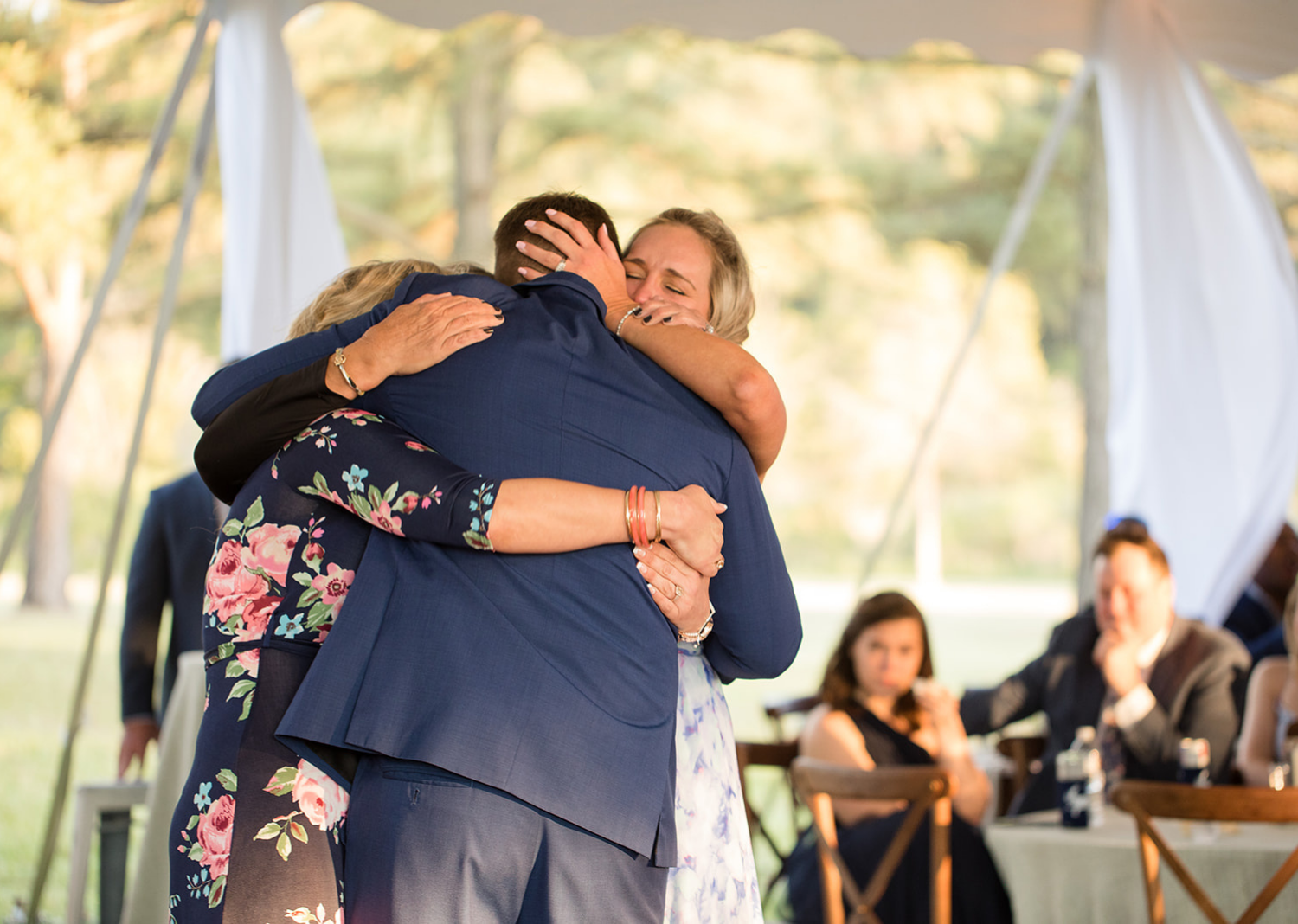 groom hugging his mother and sister