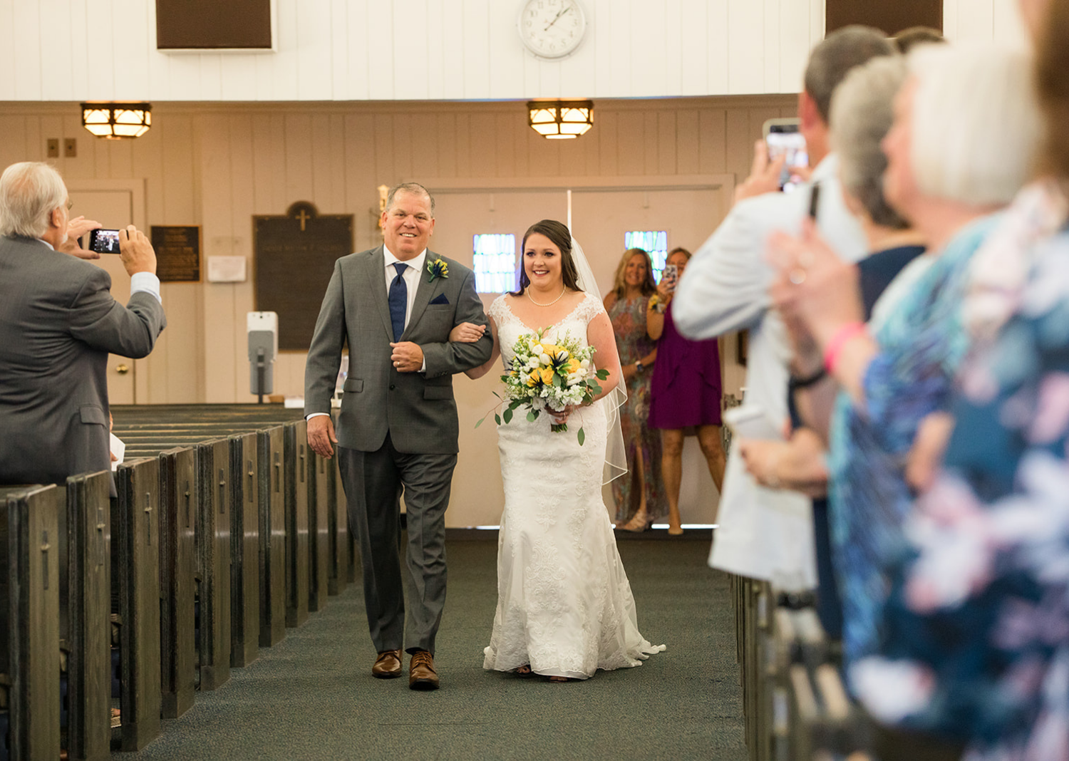 father and bride walking down the aisle