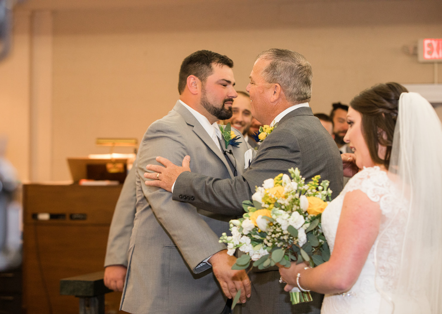 father of the bride handing bride off to the groom