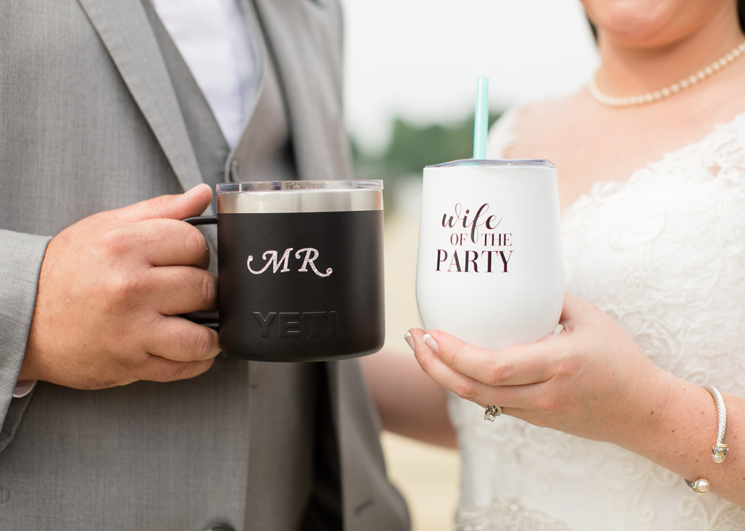 bride and groom outdoor portraits on the pier showing their personalized mugs