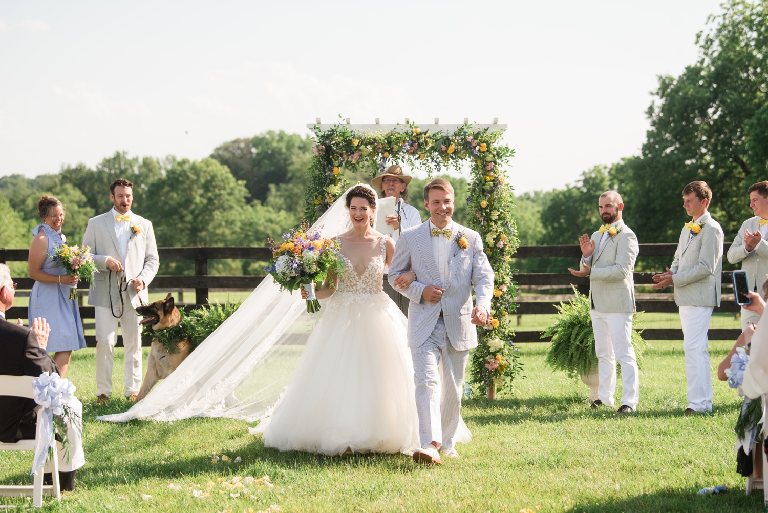 bride and groom walk down the aisle together