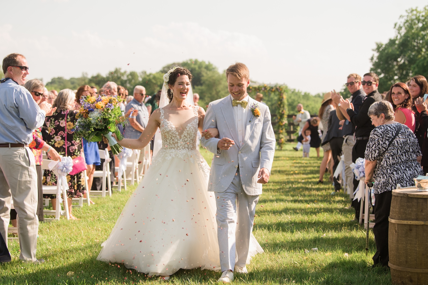 bride and groom walk down the aisle together