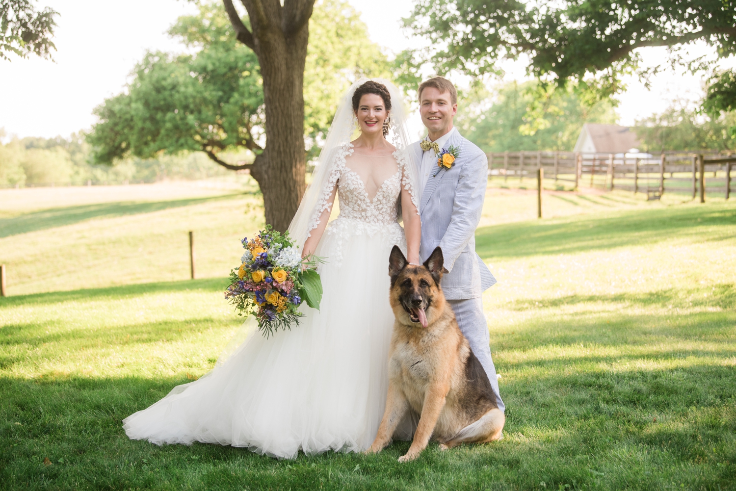 bride and groom with their German Shepherd