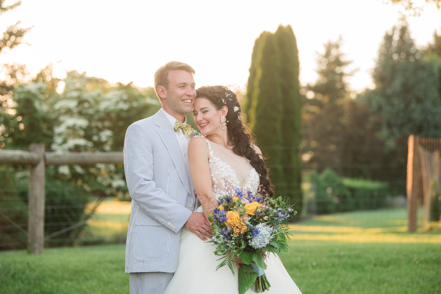 bride and groom snuggle one another