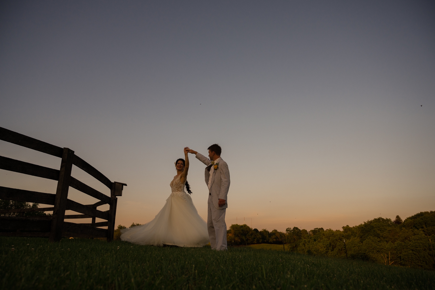 bride and groom dance into the sunset