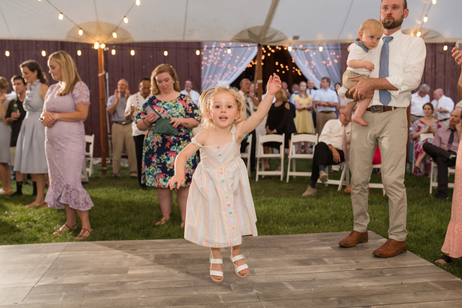 tiny wedding guest hops with joy