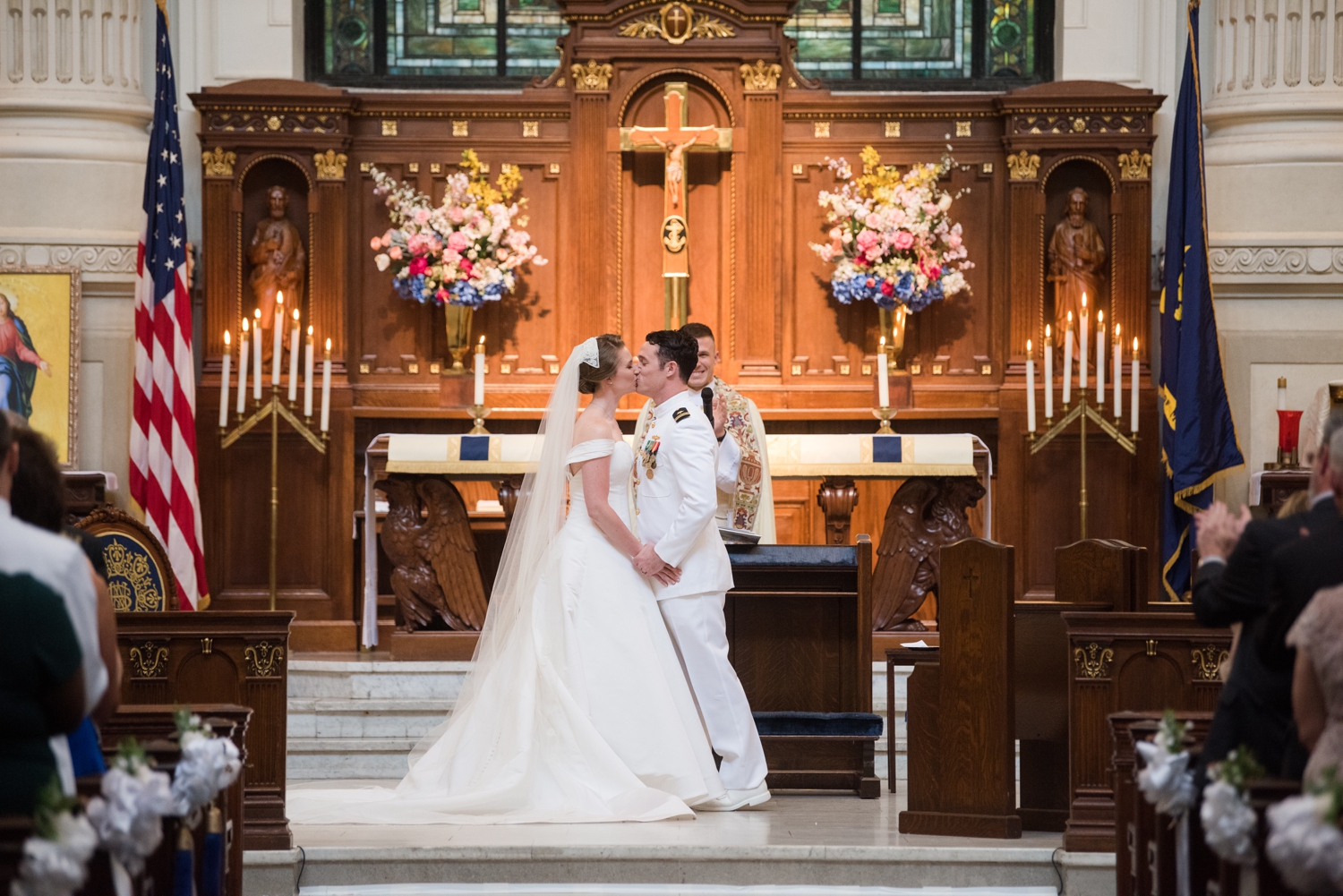 Tight shot of the bride and groom and their first kiss after the ceremony