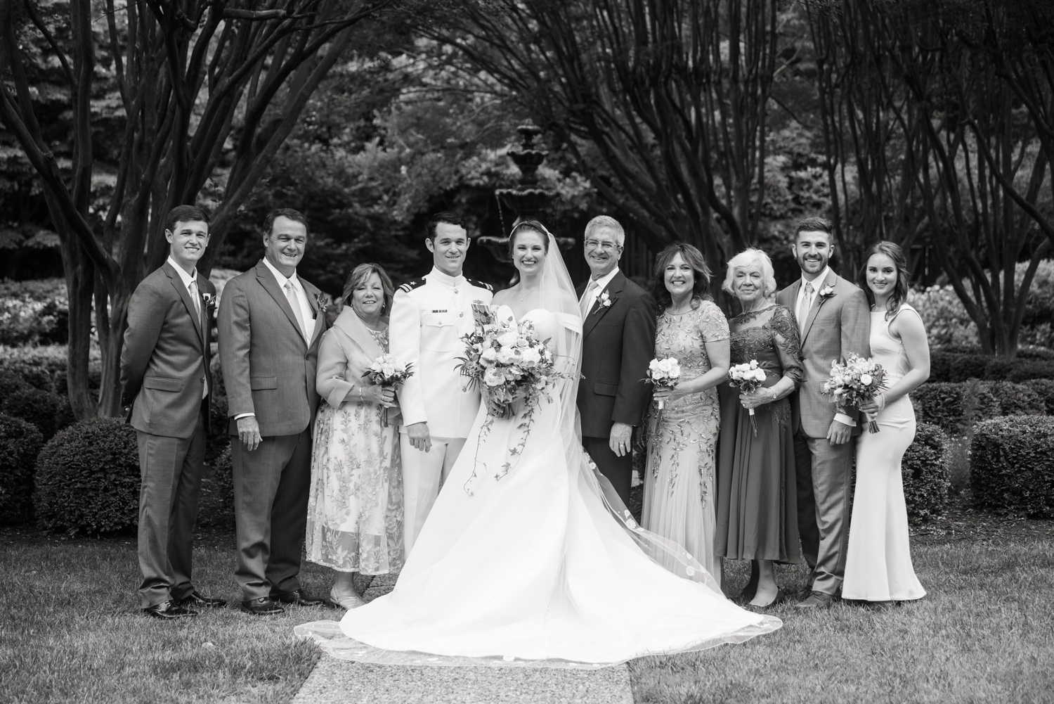 bride and groom pose for family formals