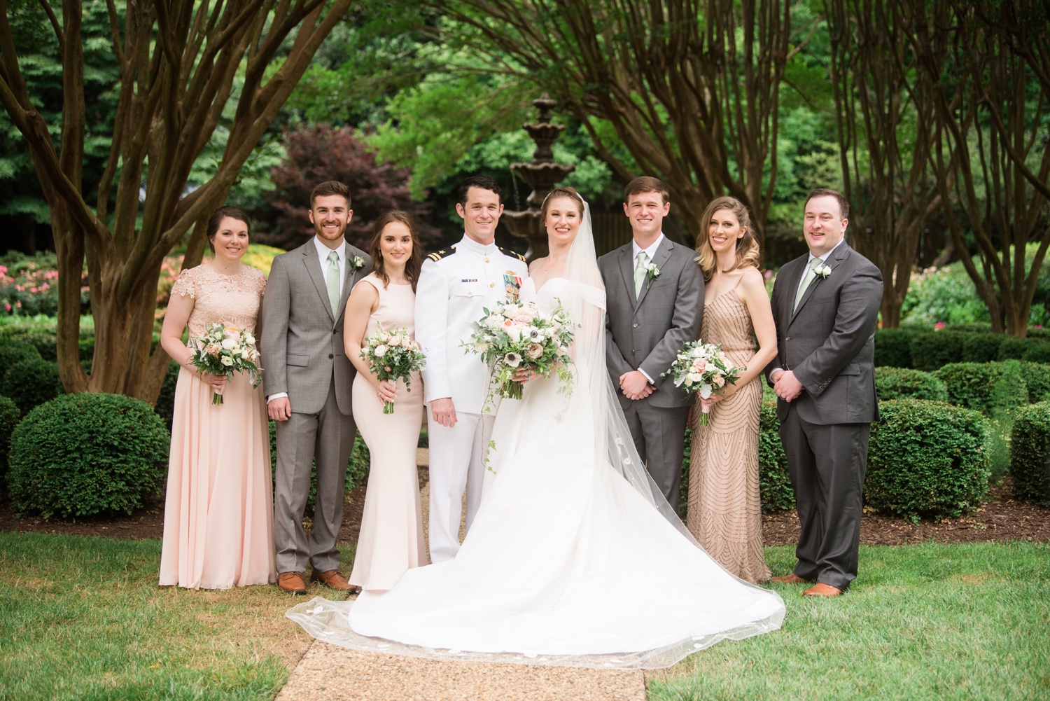 bride and groom pose for family formals