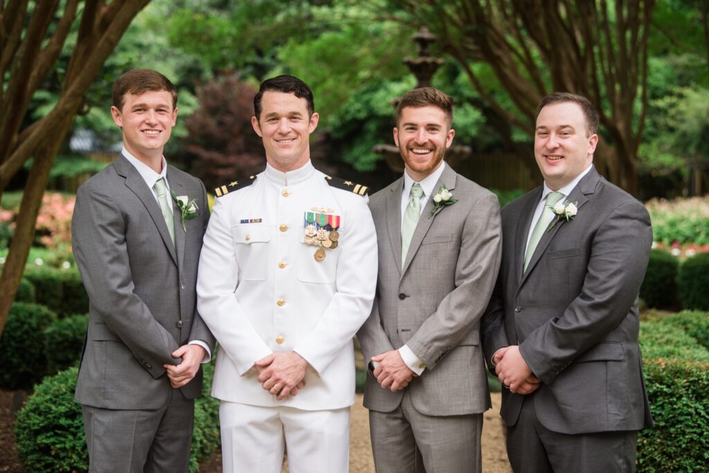 groom poses for family formals