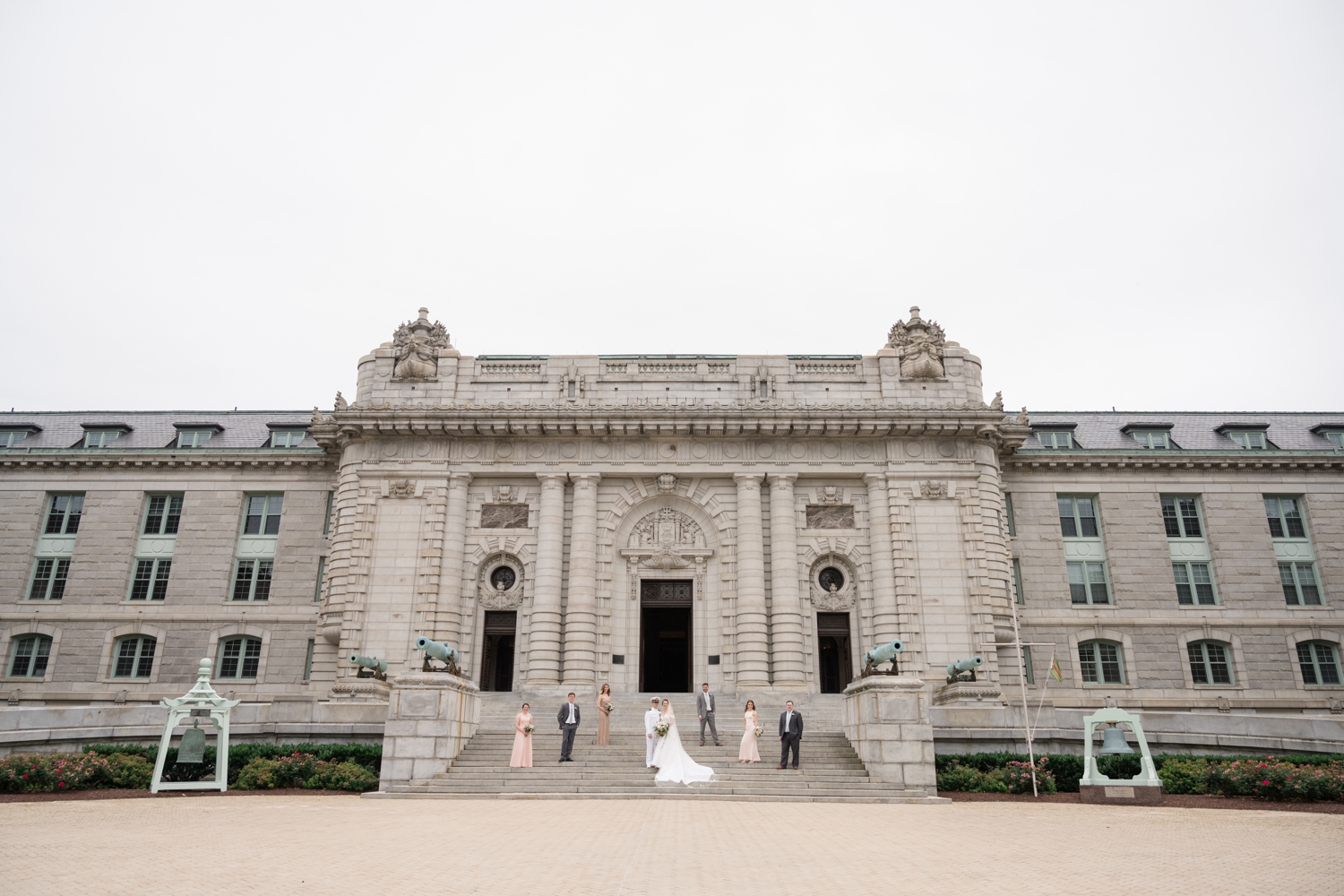 bride and groom pose with bridal party outside the Naval Chapal