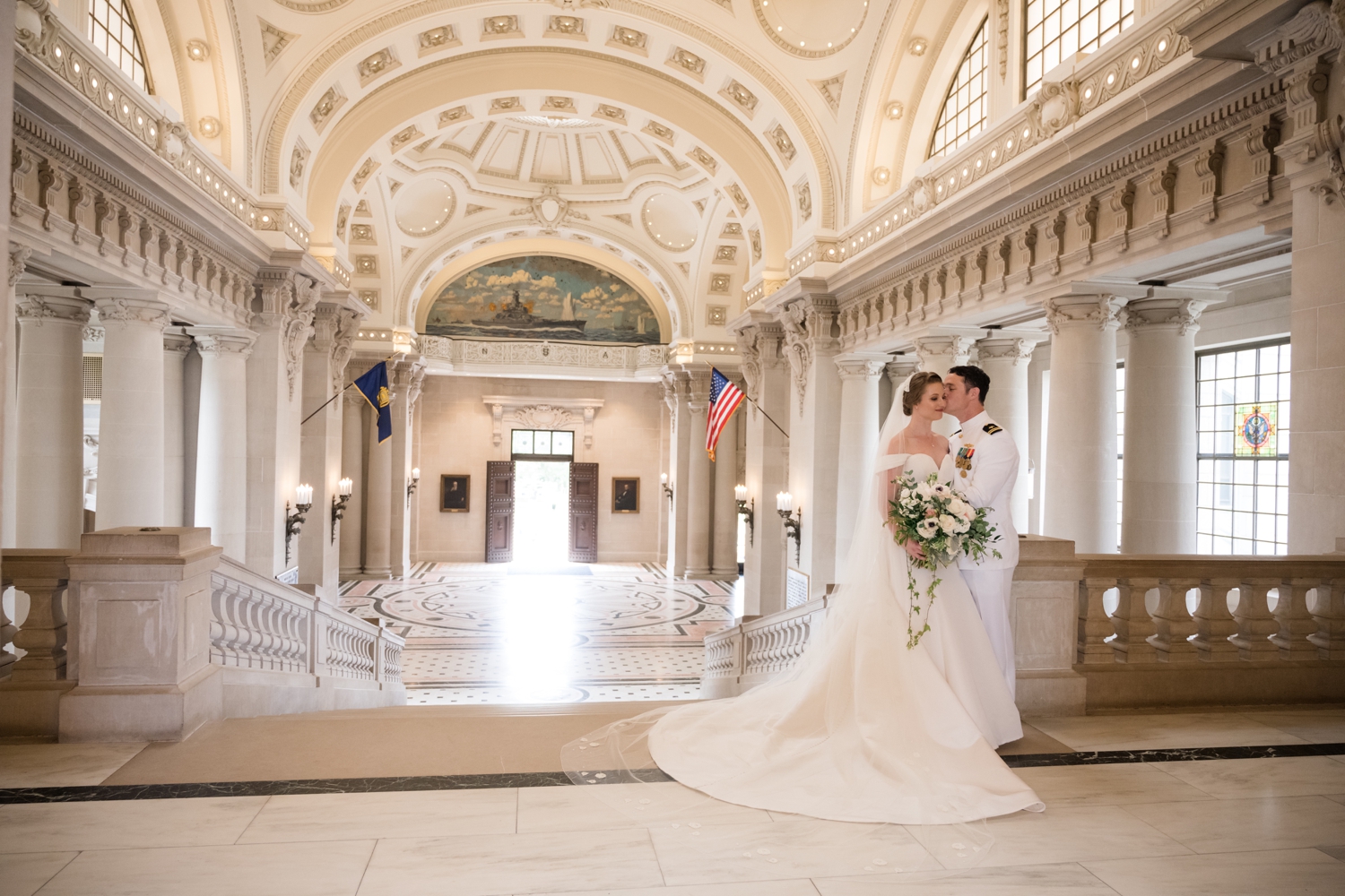 bride and groom stand close in the Naval Chapel where the ornate dome ceiling is featured