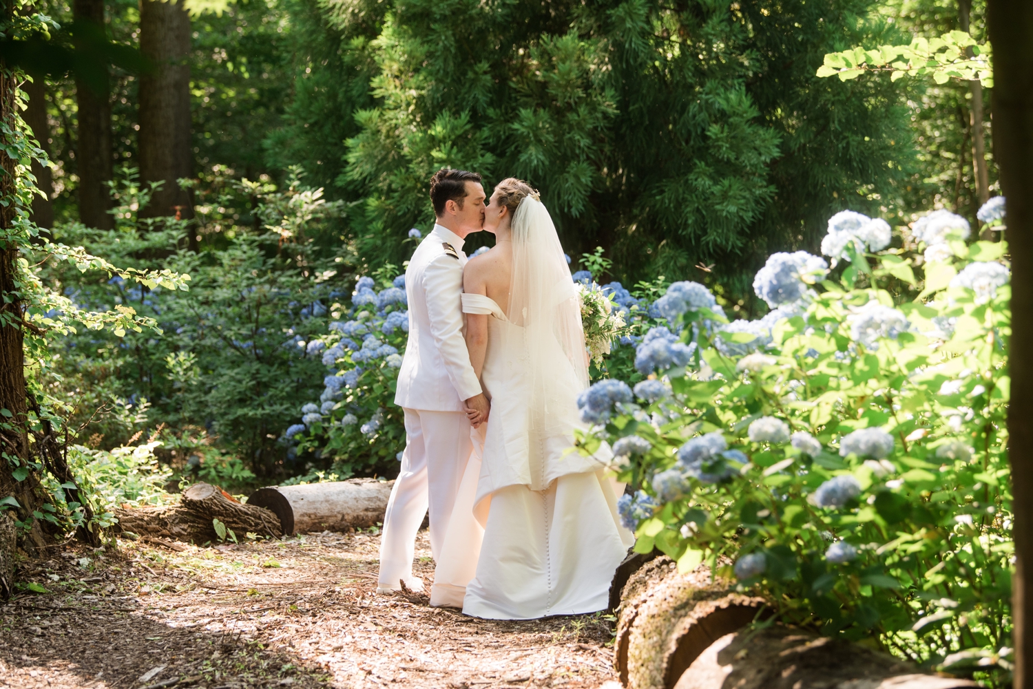 bride and groom kiss in the garden