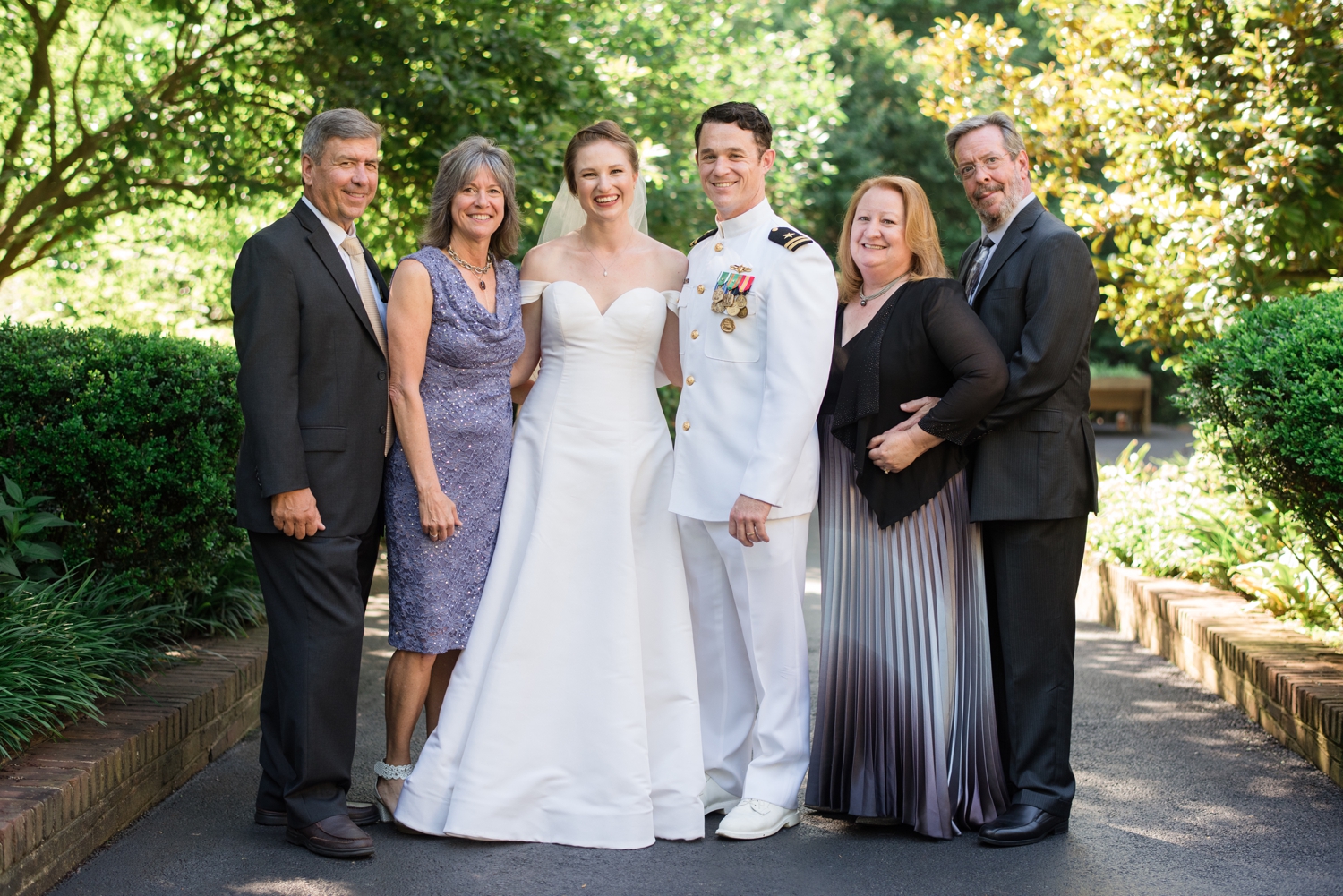 bride and groom pose for family formals