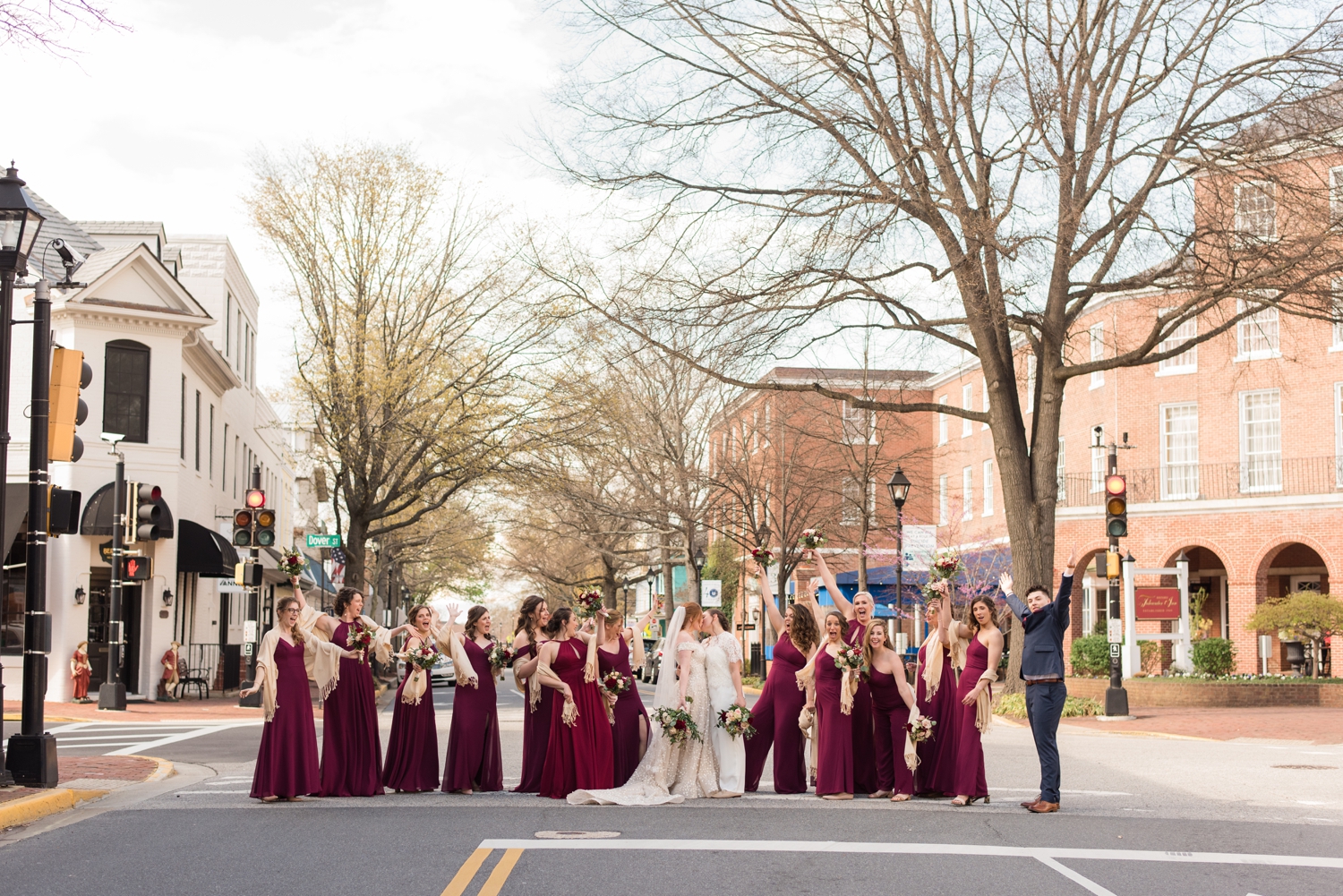 bridal party poses in the street