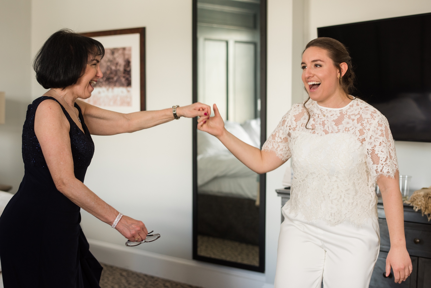 bride and her mother laugh together