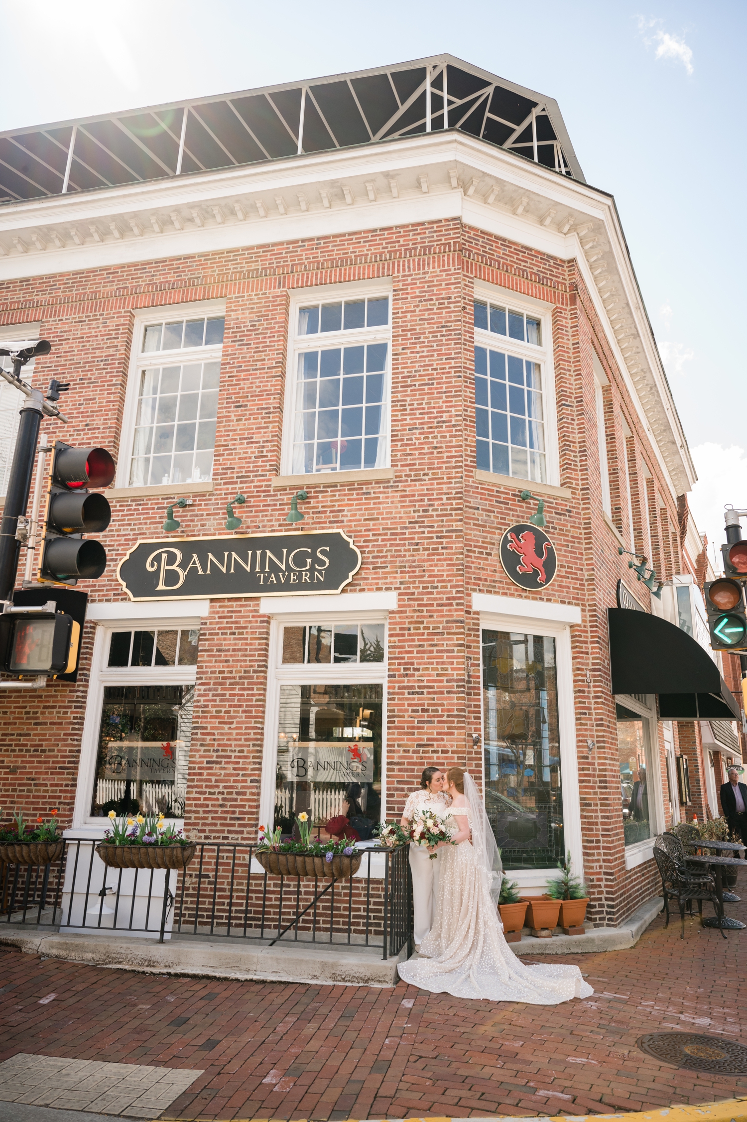 the couple poses in front of the Bannings Tavern