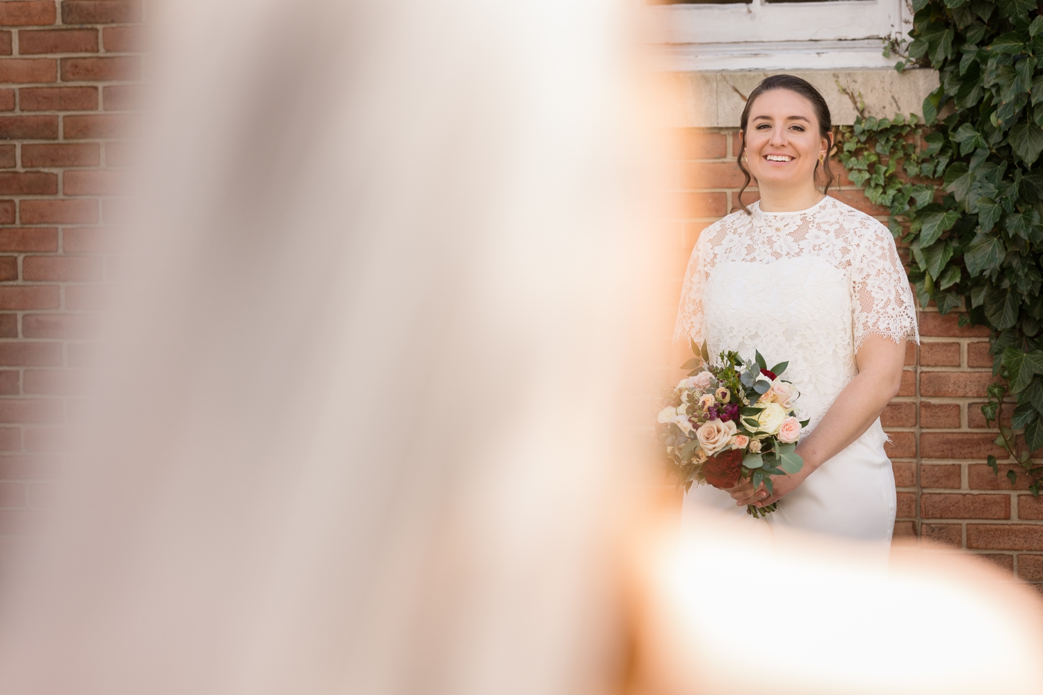 bride smiles as she looks at her partner