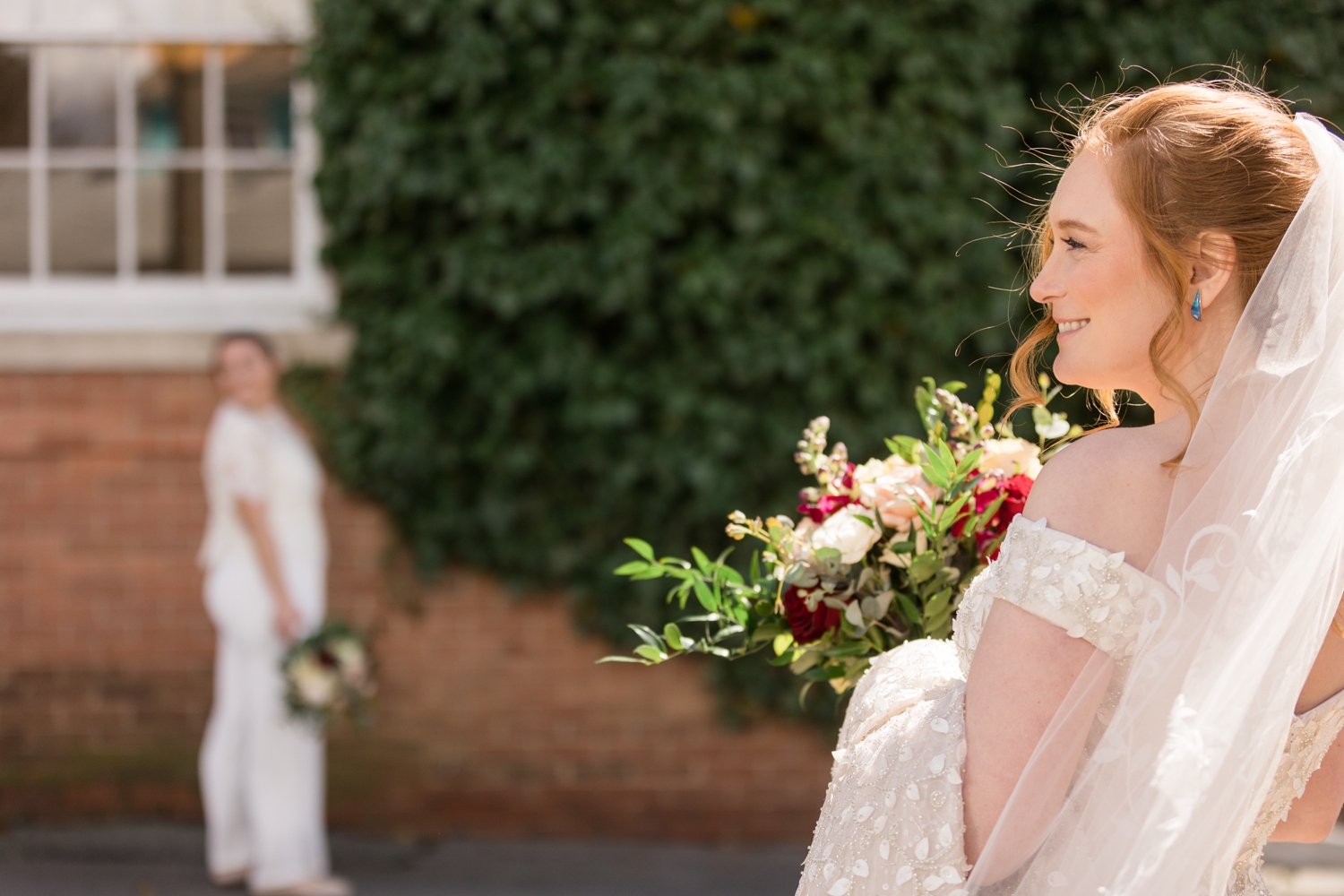 bride poses with her partner in her foreground