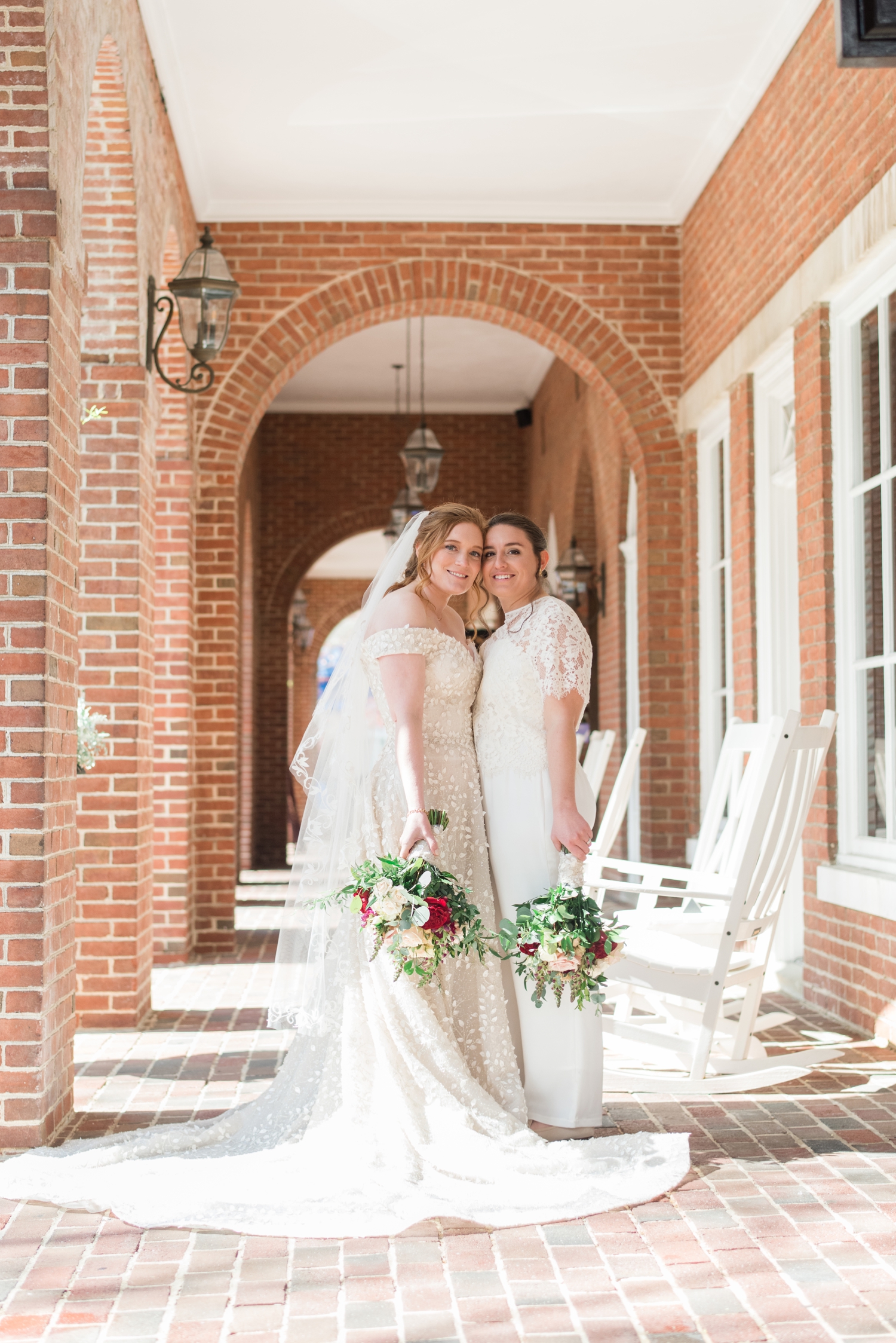 brides pose cheek to cheek at the Tidewater Inn