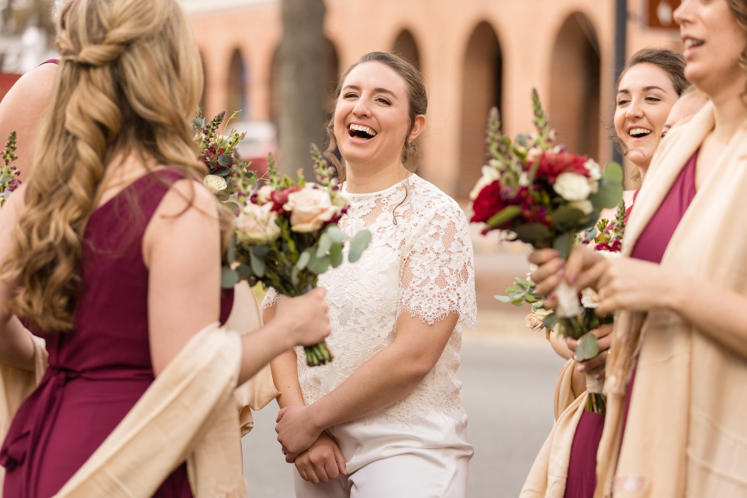 bride laughs with her bridesmaids