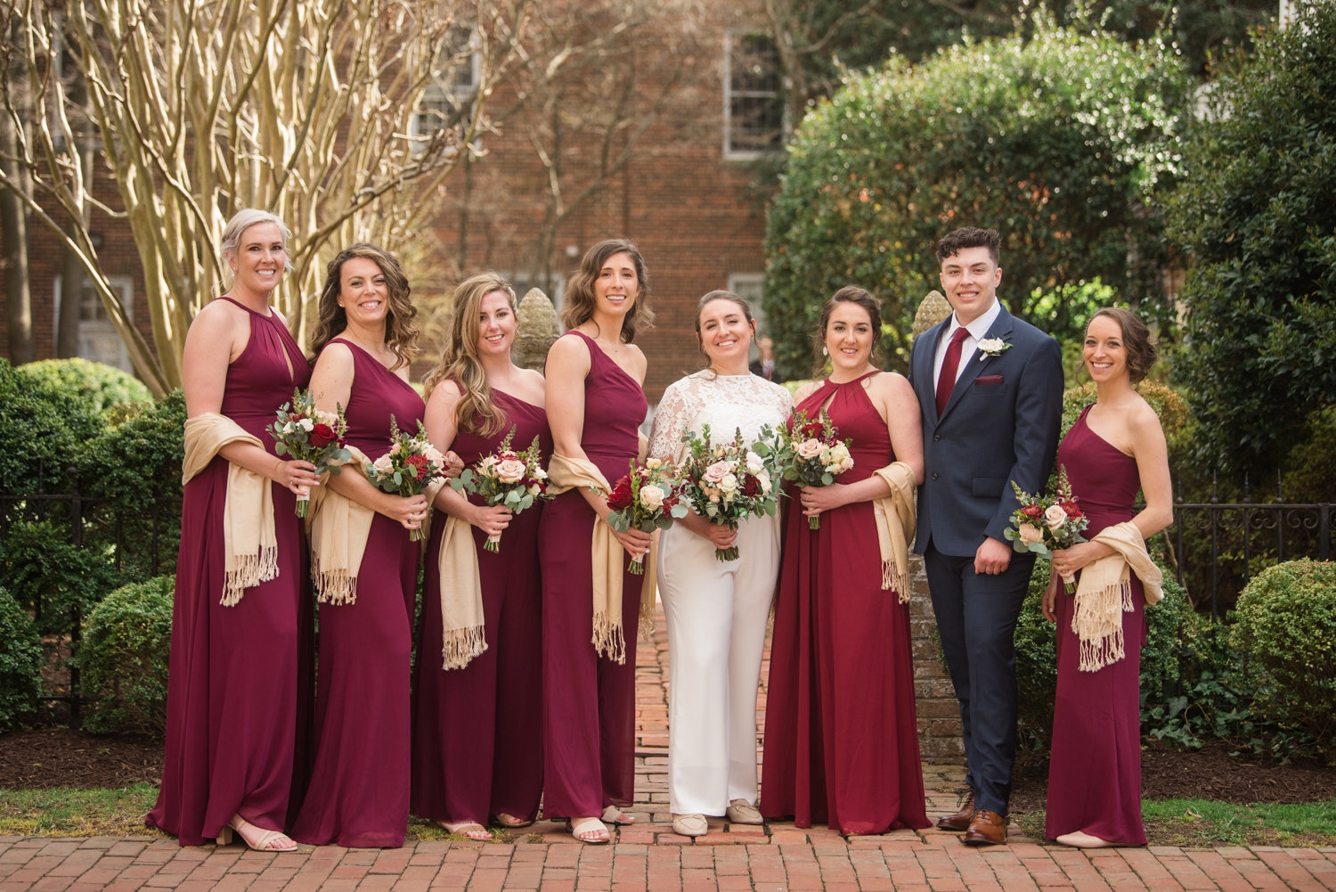 brides pose with bridal party