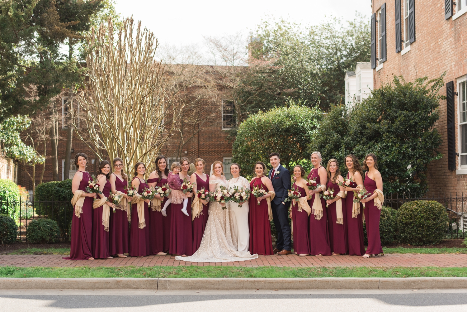 brides pose with bridal party