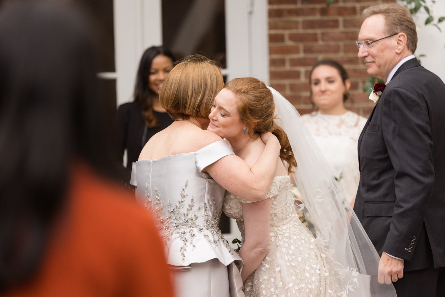 bride hugs her mom during the ceremony