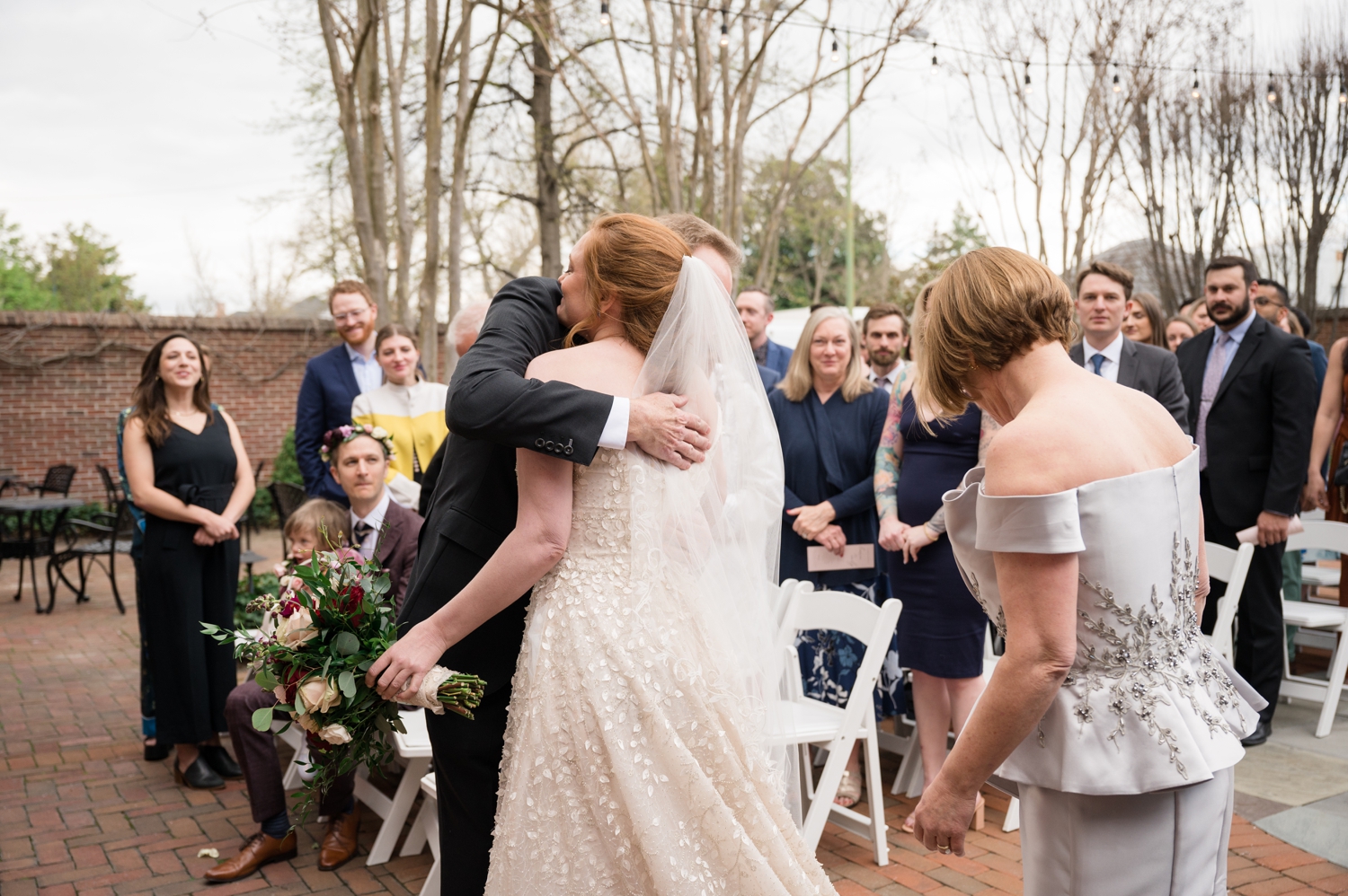 bride hugs her dad at the ceremony