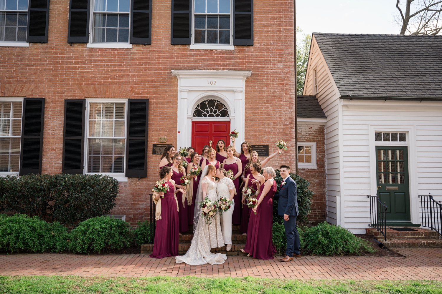 bridal party poses with couple at the Tidewater Inn