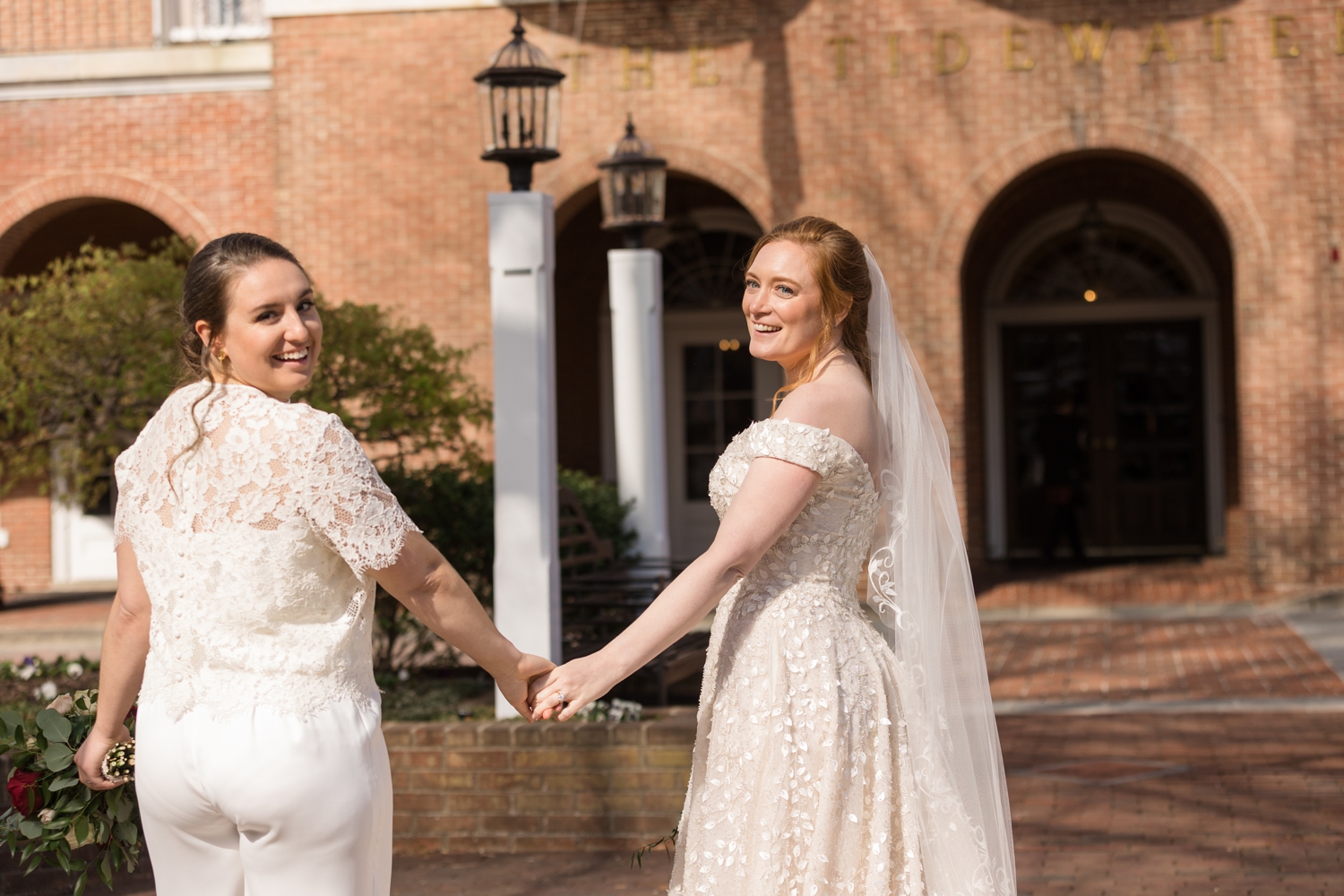 brides posing in front of the Tidewater Inn