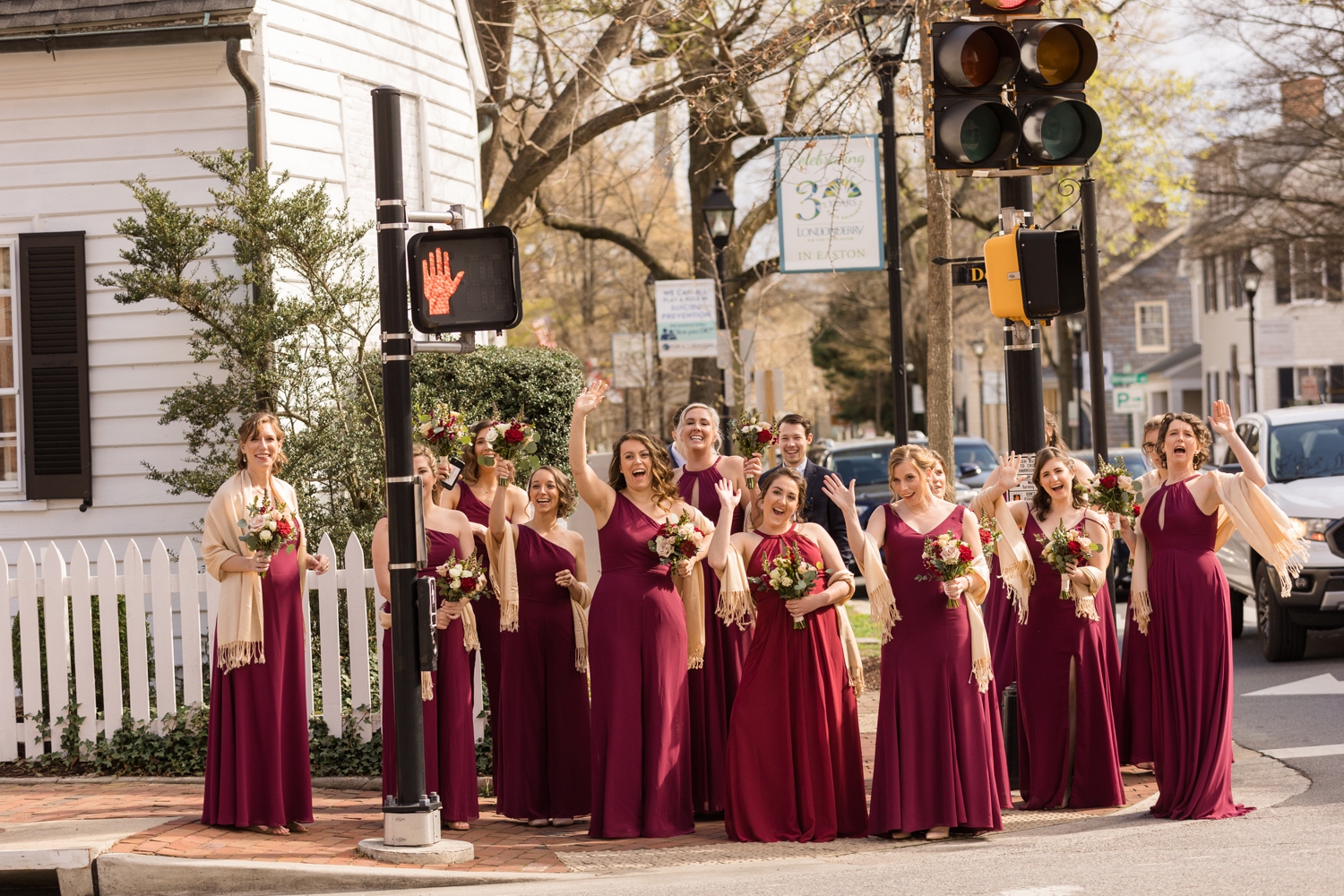 bridal party waves at the couple across the street from the Tidewater Inn