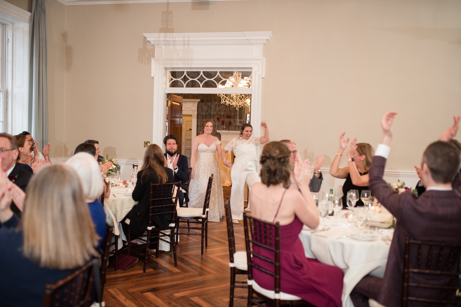 brides enter their reception at the Tidewater Inn