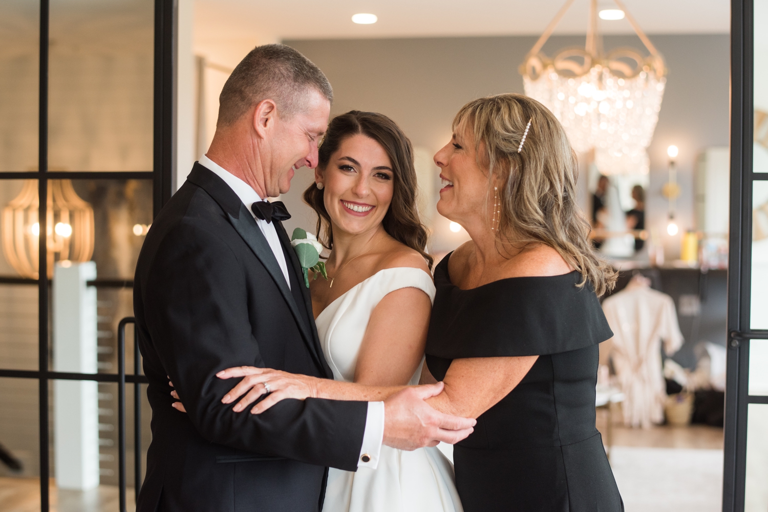 the parents of the bride give her a hug