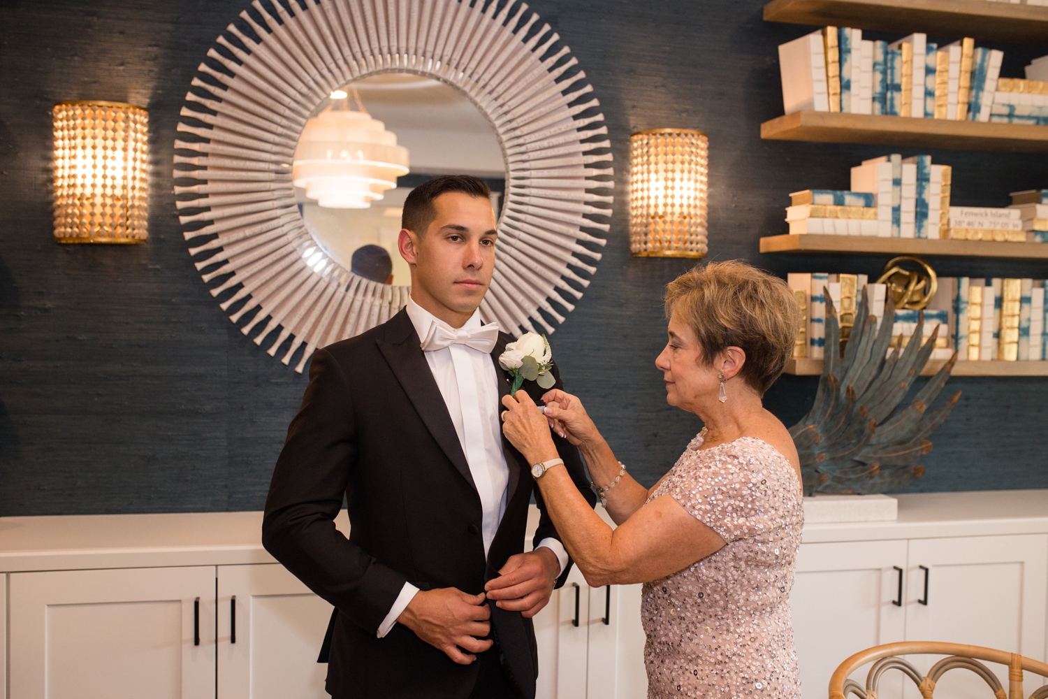 the groom's mother pins his boutonniere 