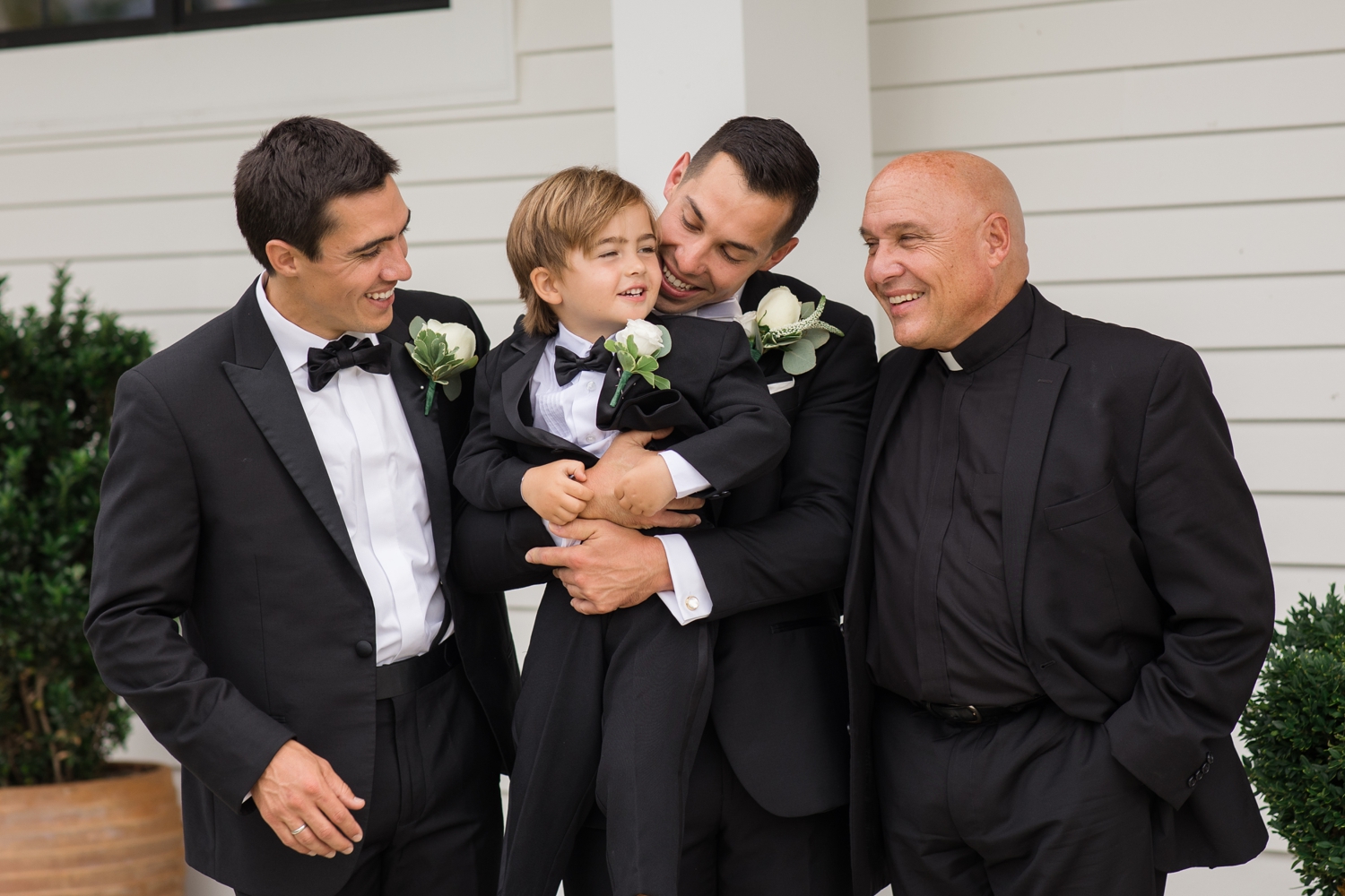 groomsmen pose with ring bearer