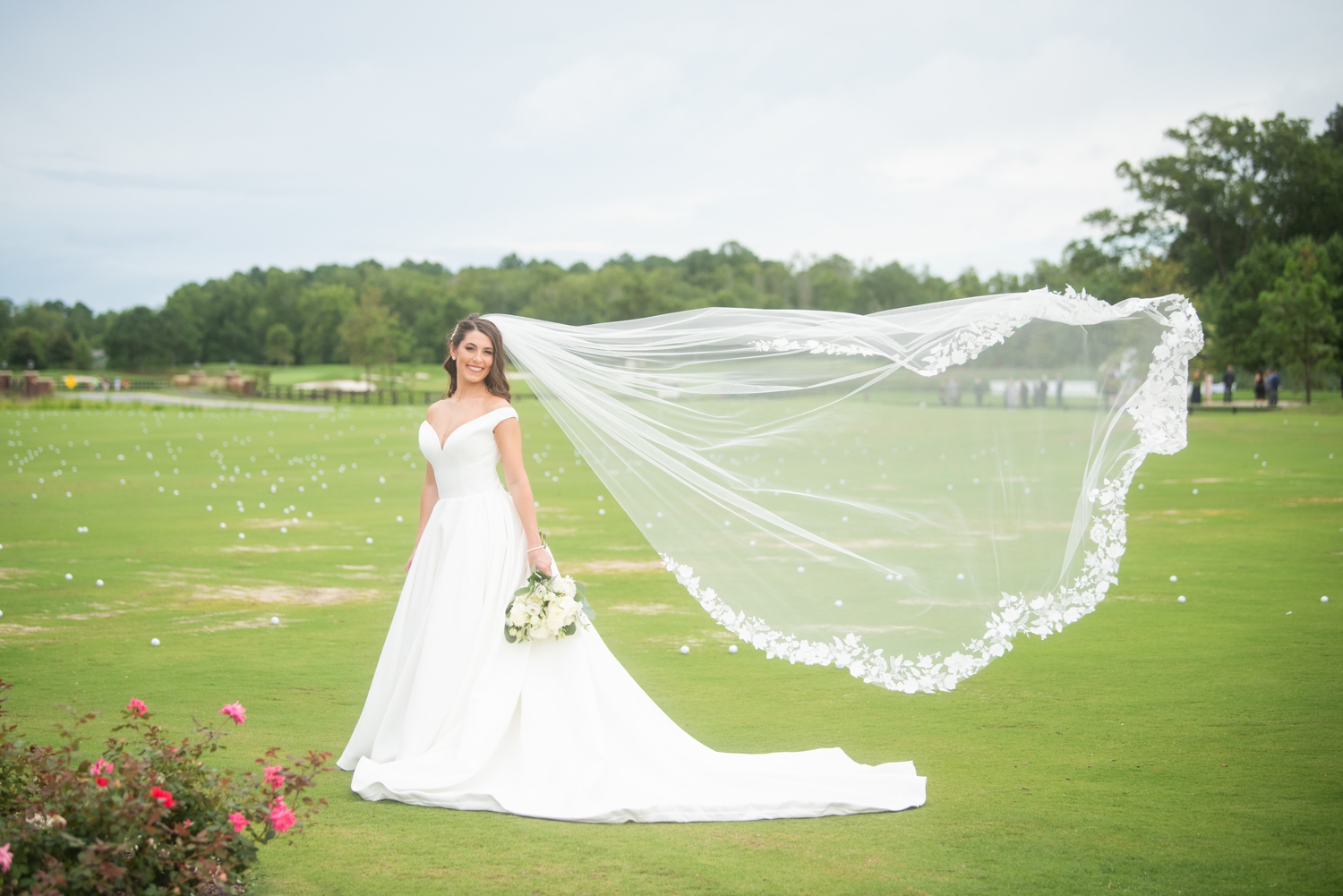 bride poses with windswept veil 