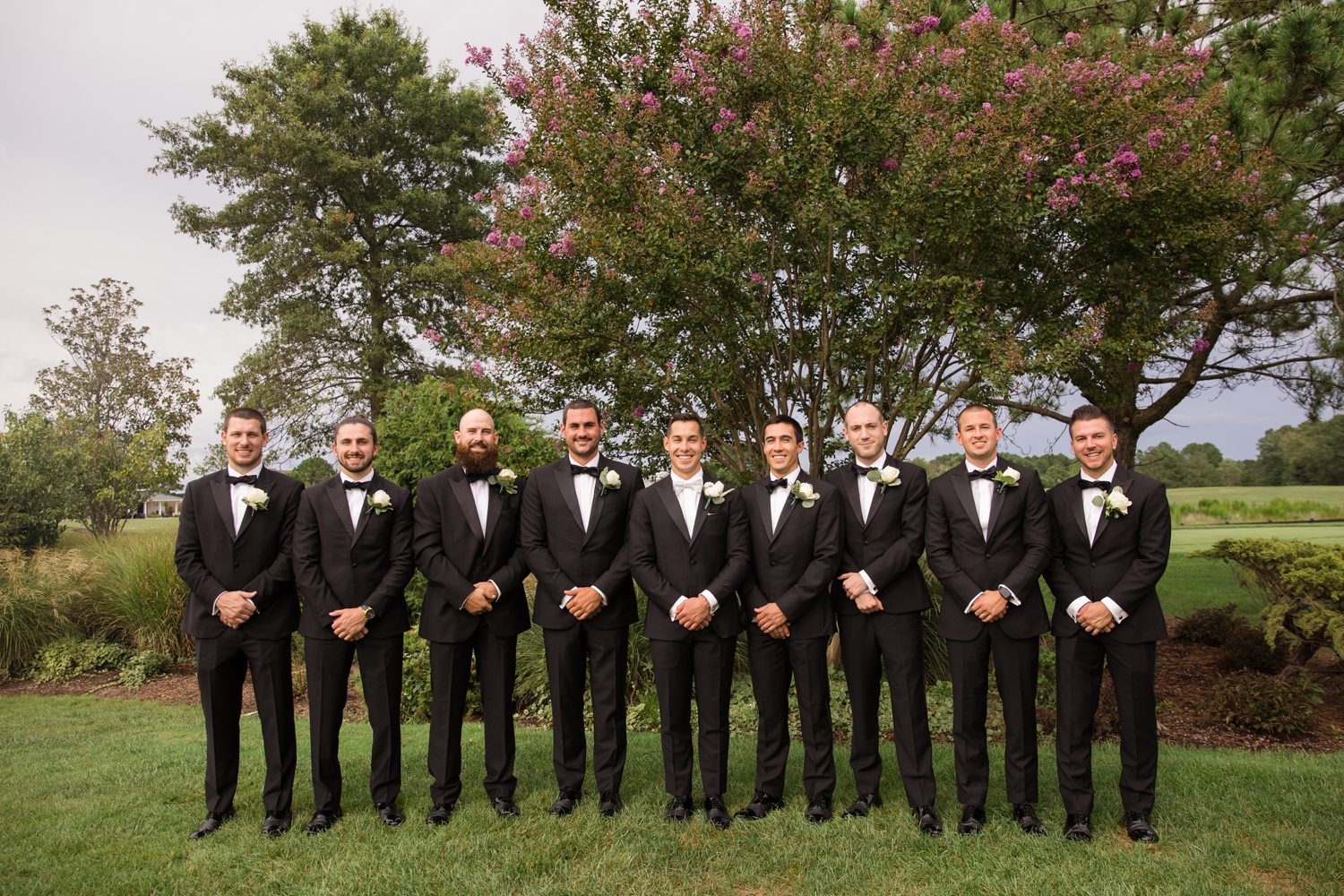 groom poses with groomsmen