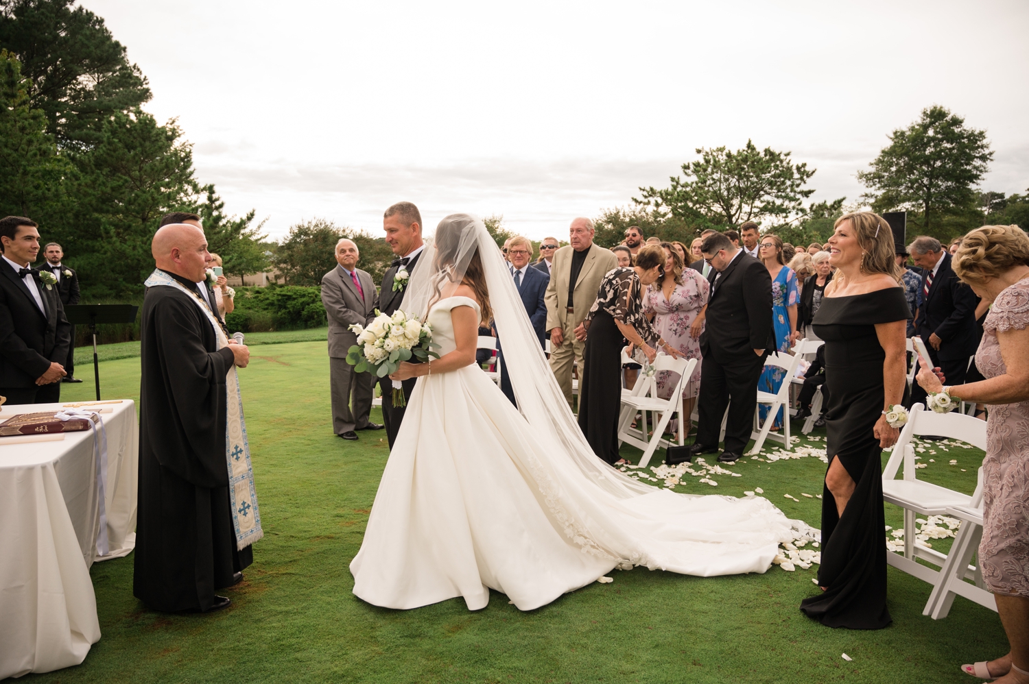 father of the bride walks his daughter down the aisle. 