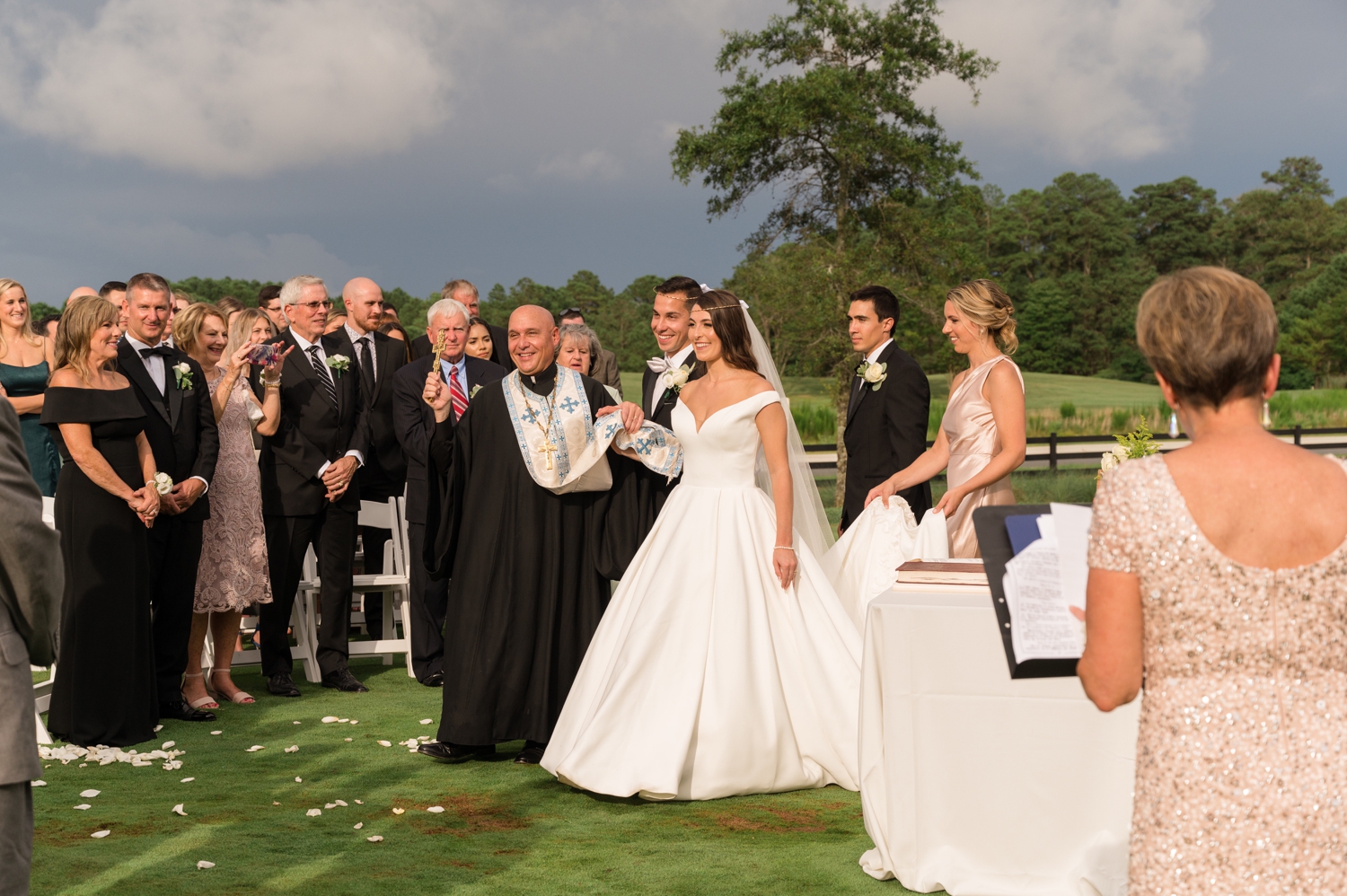 bride and groom with wedding officiant