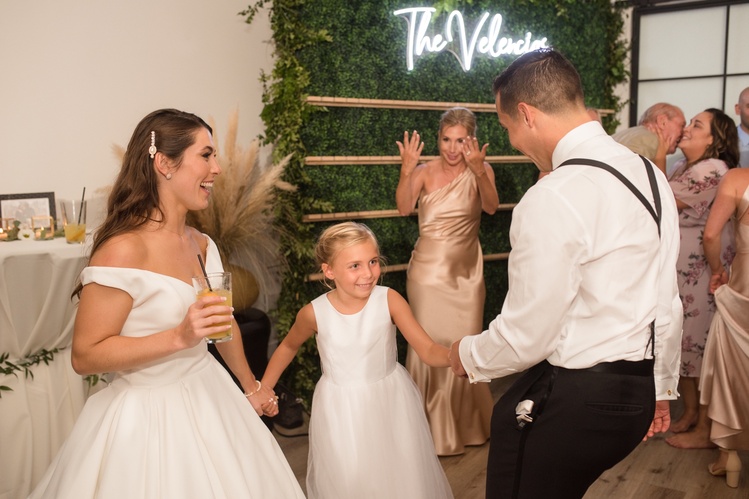 bride and groom with flower girl