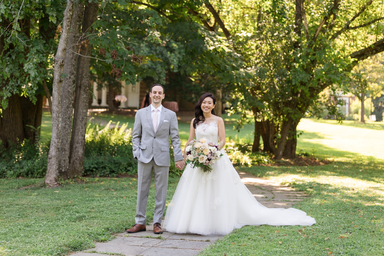 bride and groom pose together on the grounds at Woodend Sanctuary & Mansion 