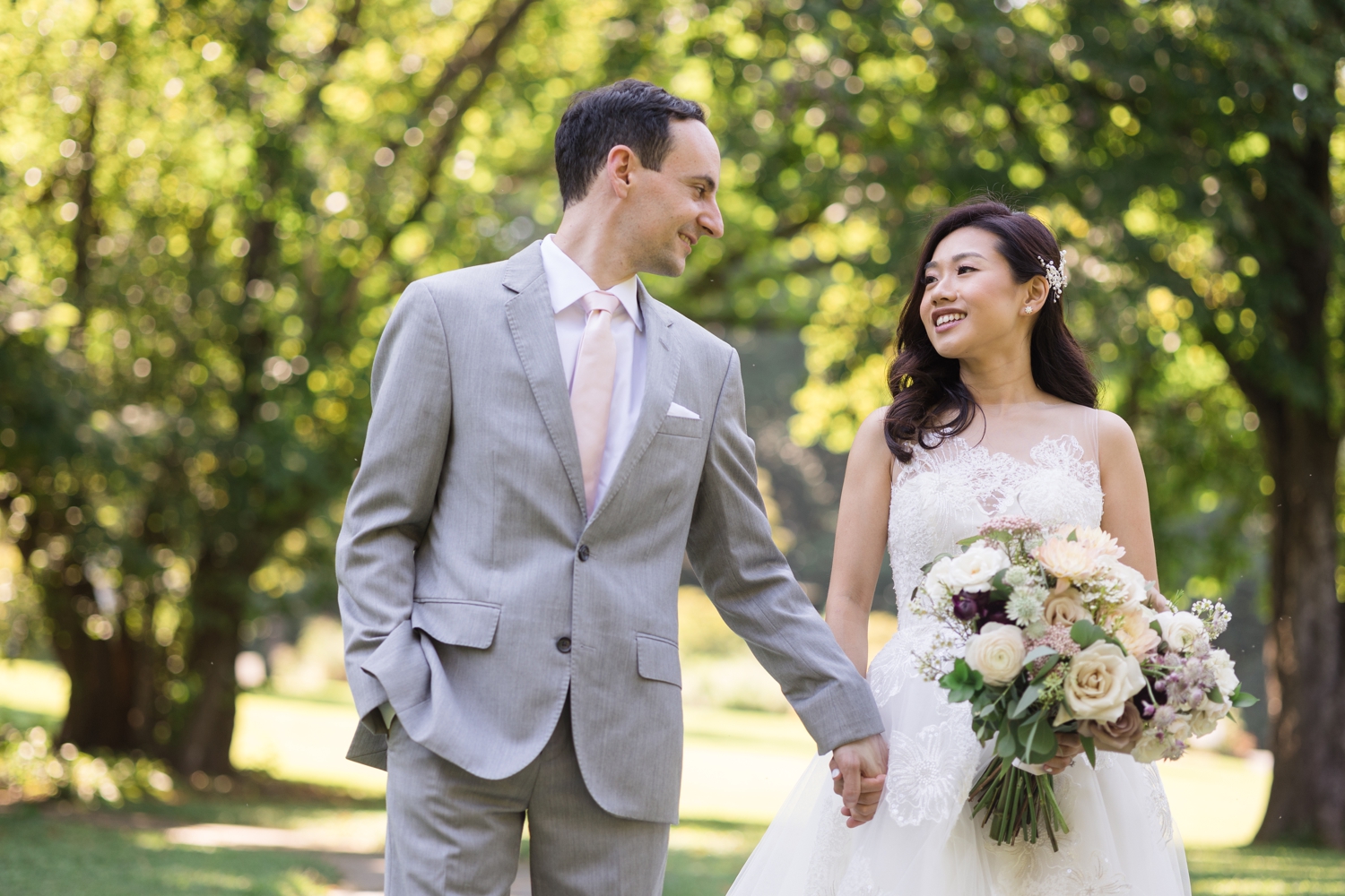 bride and groom smile at each other on the grounds at Woodend Sanctuary & Mansion 