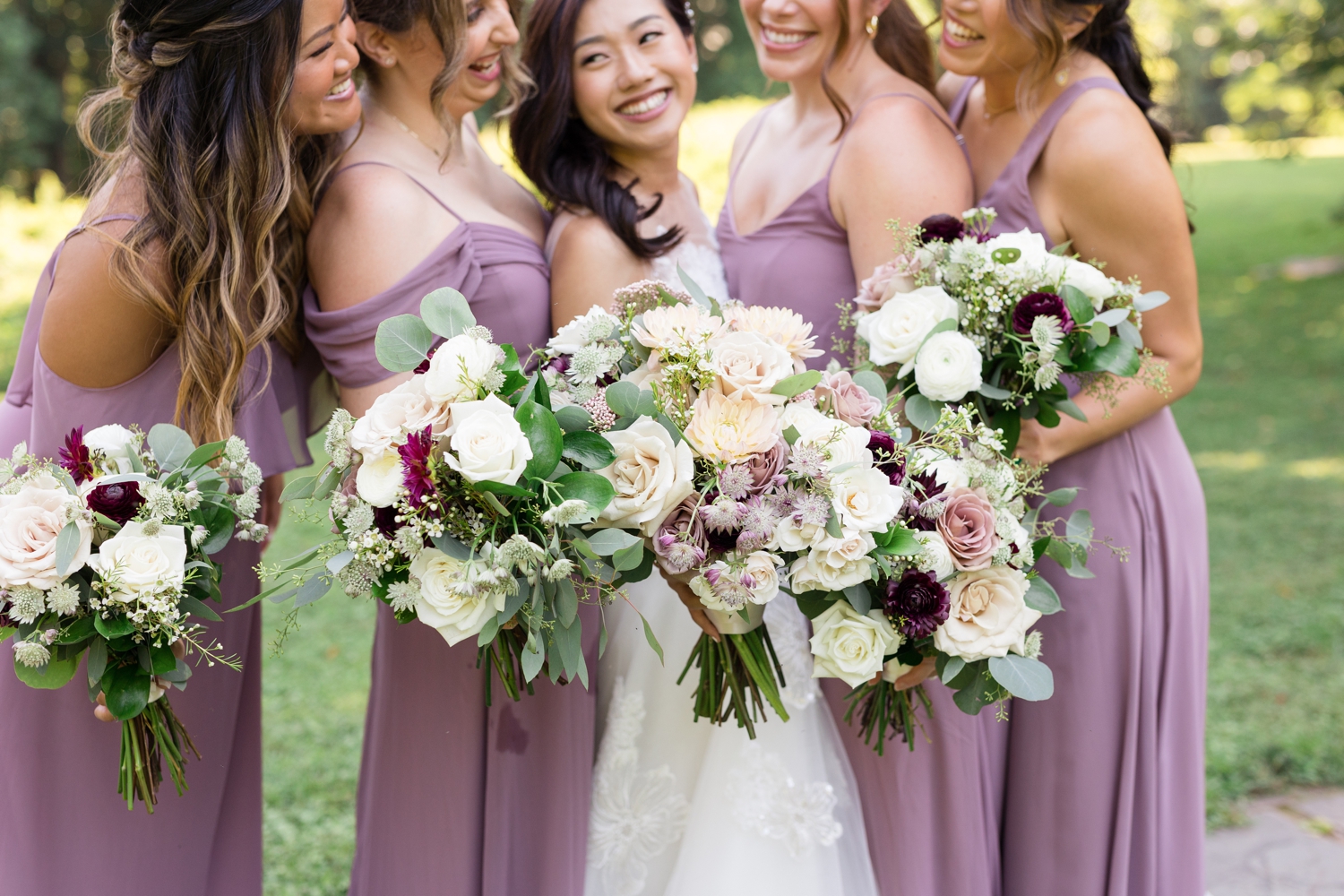 bride and bridesmaids show off bouquets at Woodend Sanctuary & Mansion 