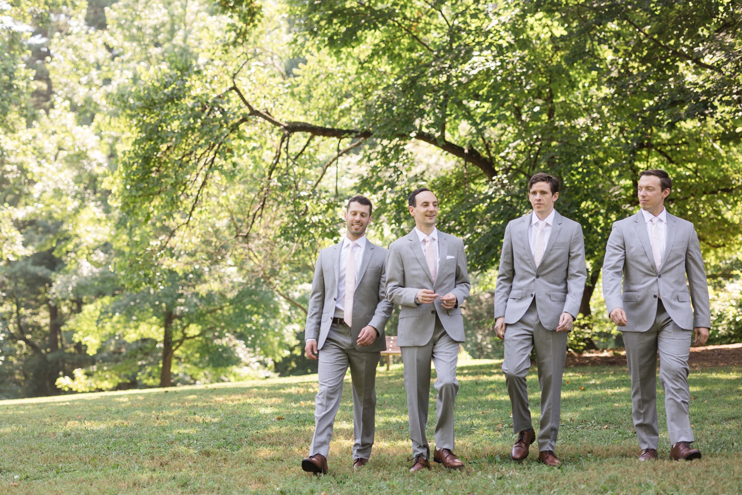 groom and groomsmen walk the grounds at Woodend Sanctuary & Mansion 